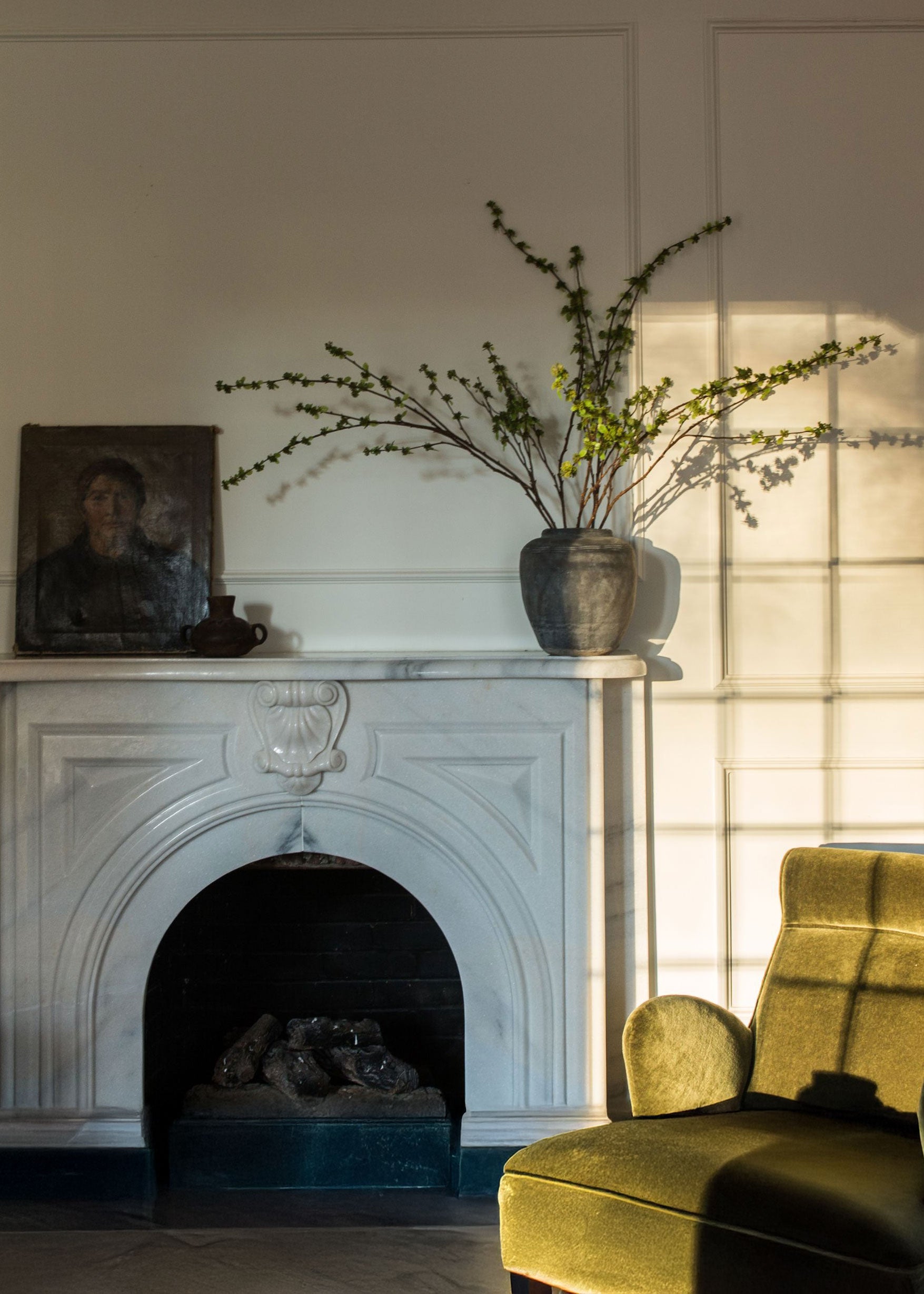 statement stems afloral artificial green budding branches styled in a concrete vase
