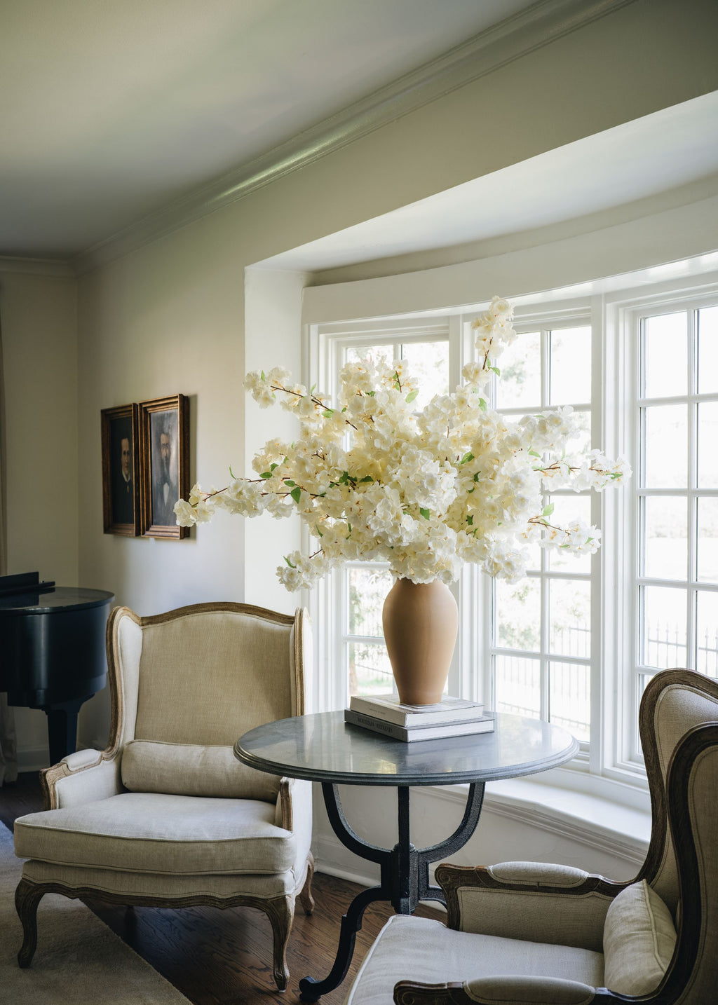 Statement flower arrangement with cherry blossoms and a tall terra cotta vase