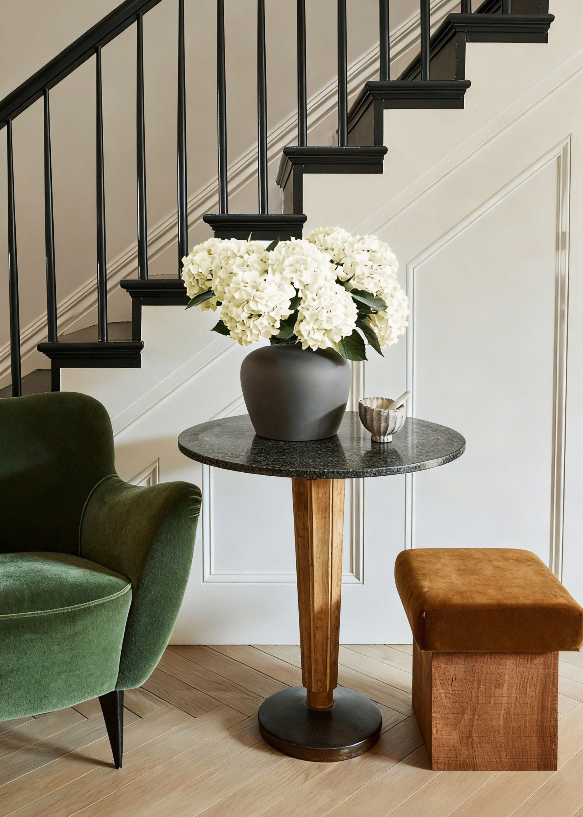 cream white hydrangeas styled on a small table in the afloral slate vase