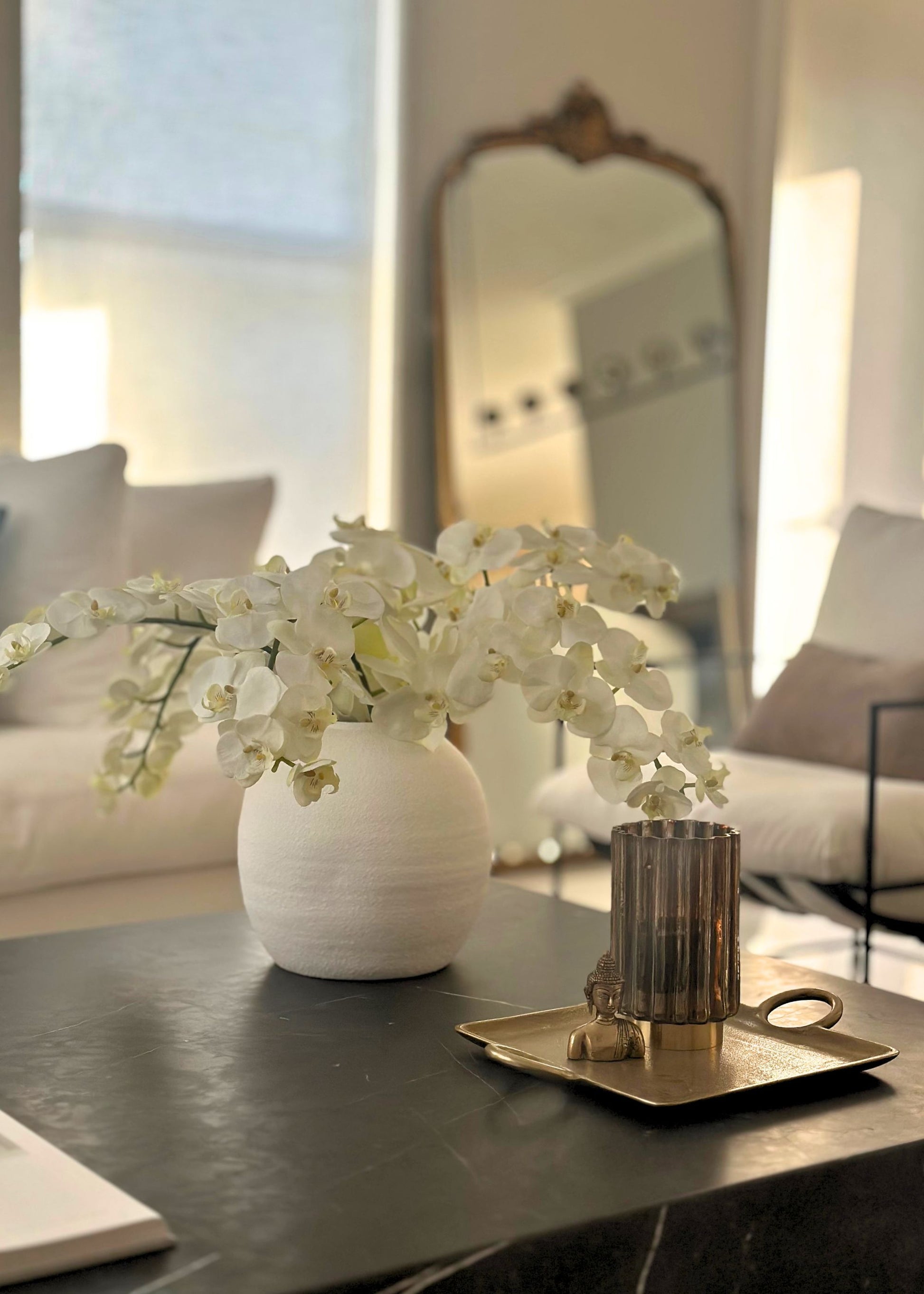 White Konos vase with premium artificial orchid flowers on a coffee table