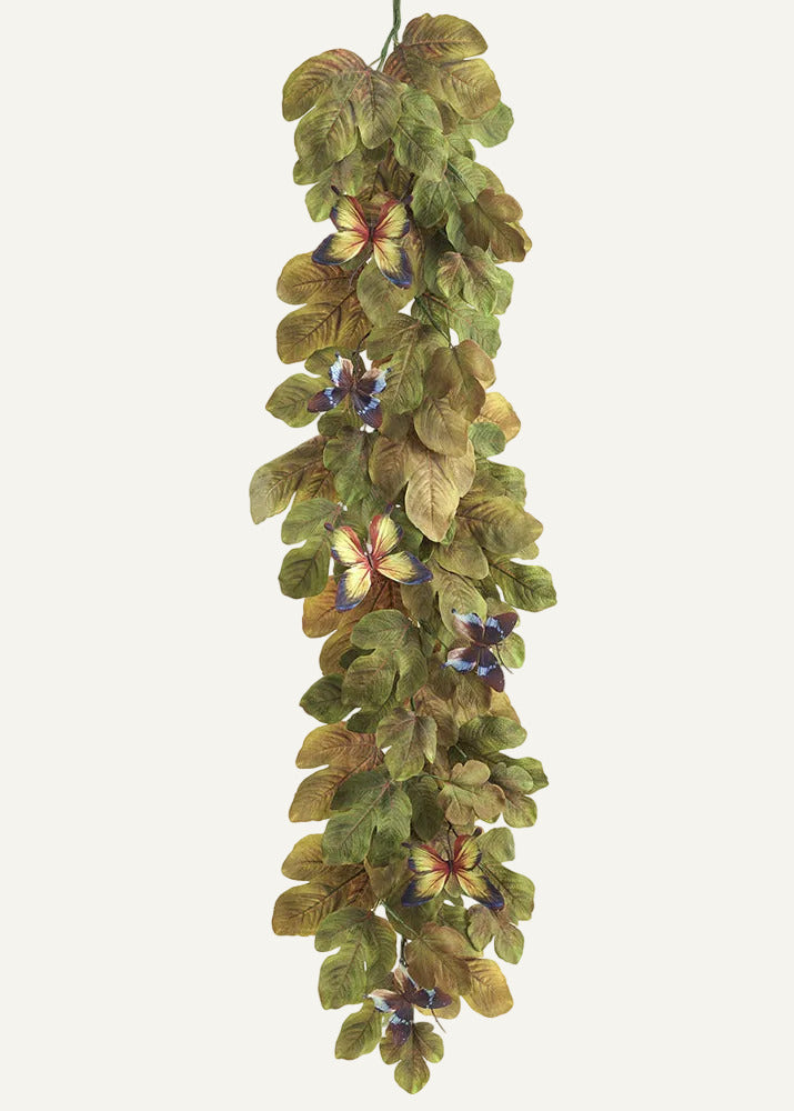Artificial floral garland with green leaves and colorful flowers on a white background