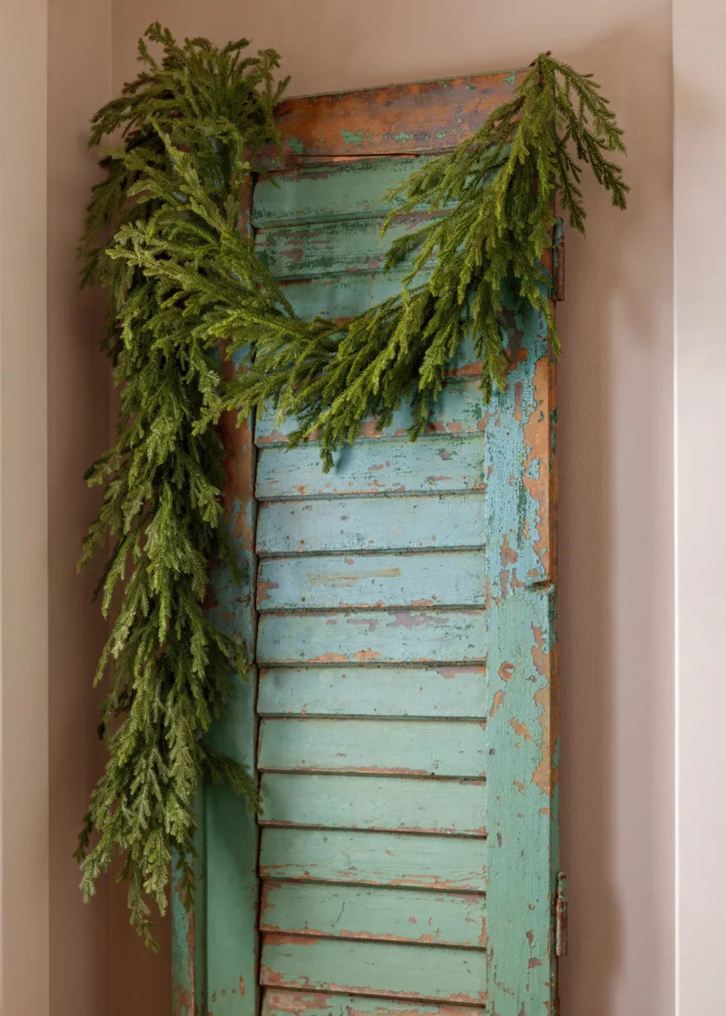 Deluxe Norwegian Spruce Garland Hanging on a Door