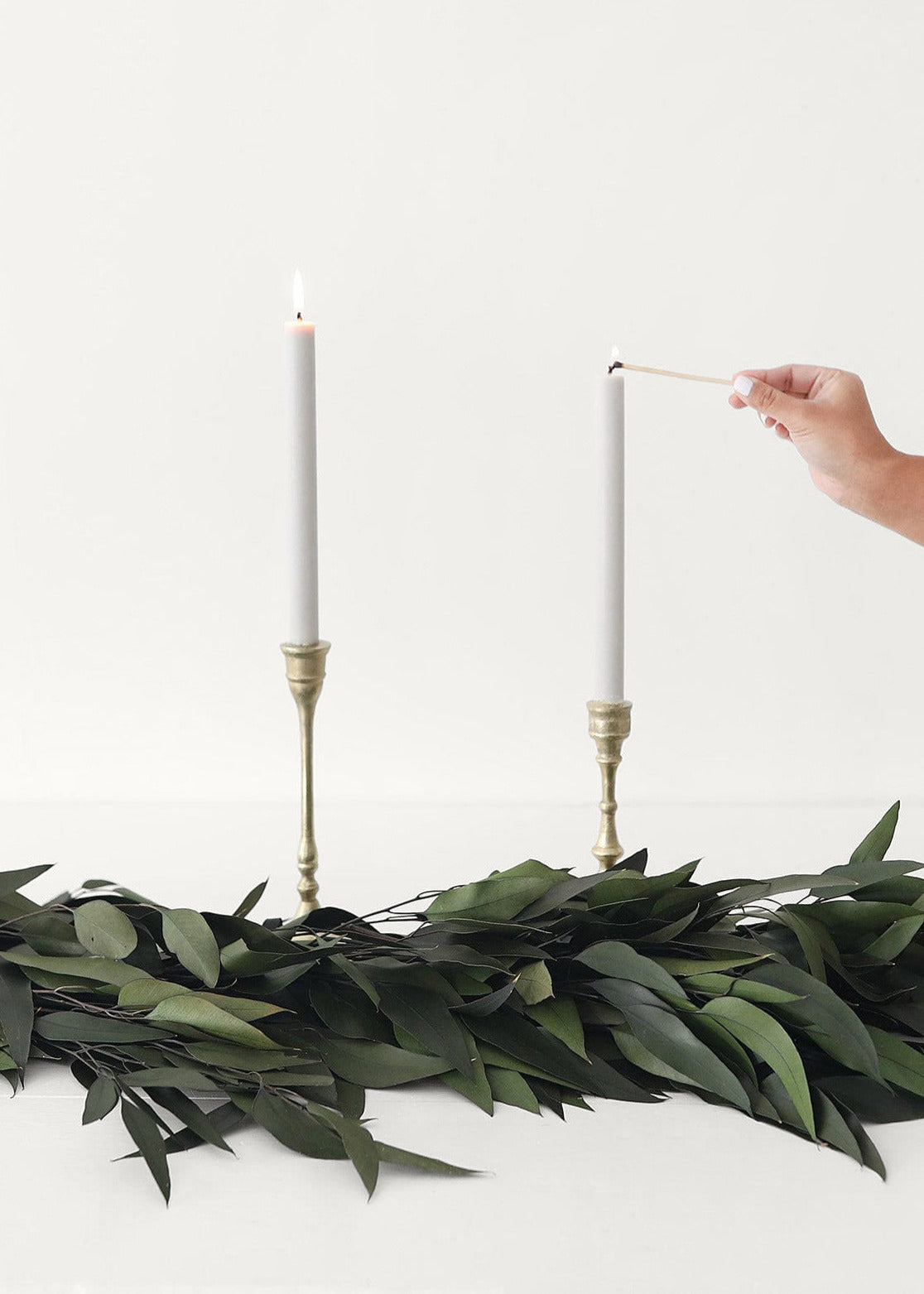 Green Preserved Weeping Eucalyptus Garland and Gold Candle Holders at Afloral