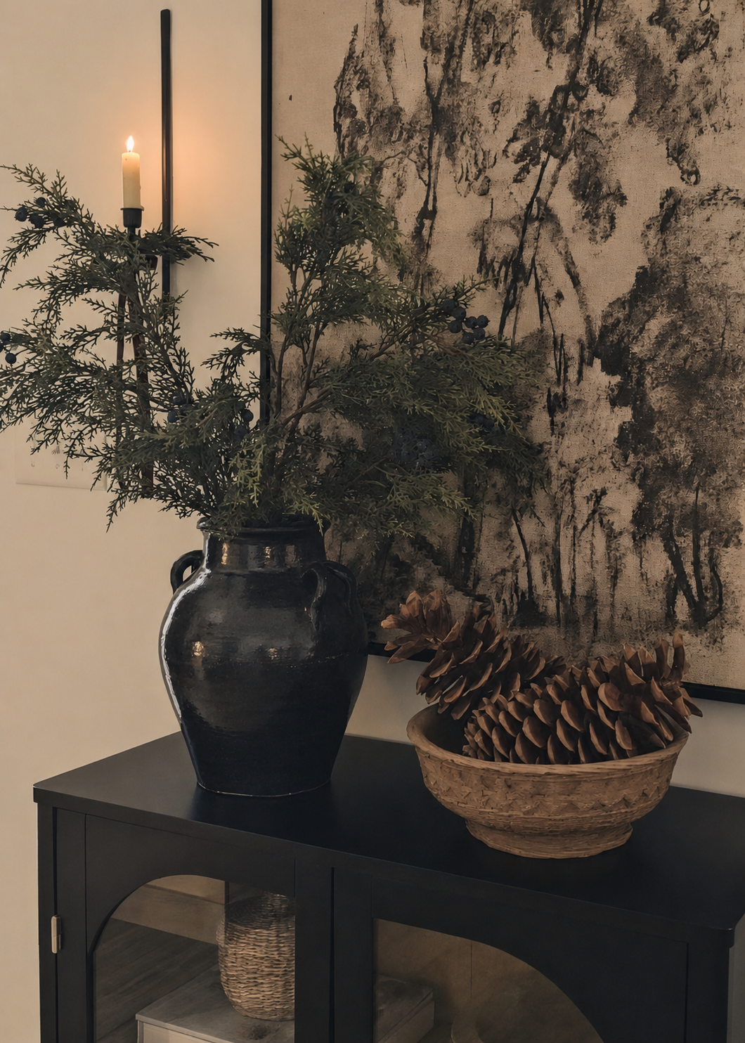 Juniper branches styled in black vase with handles