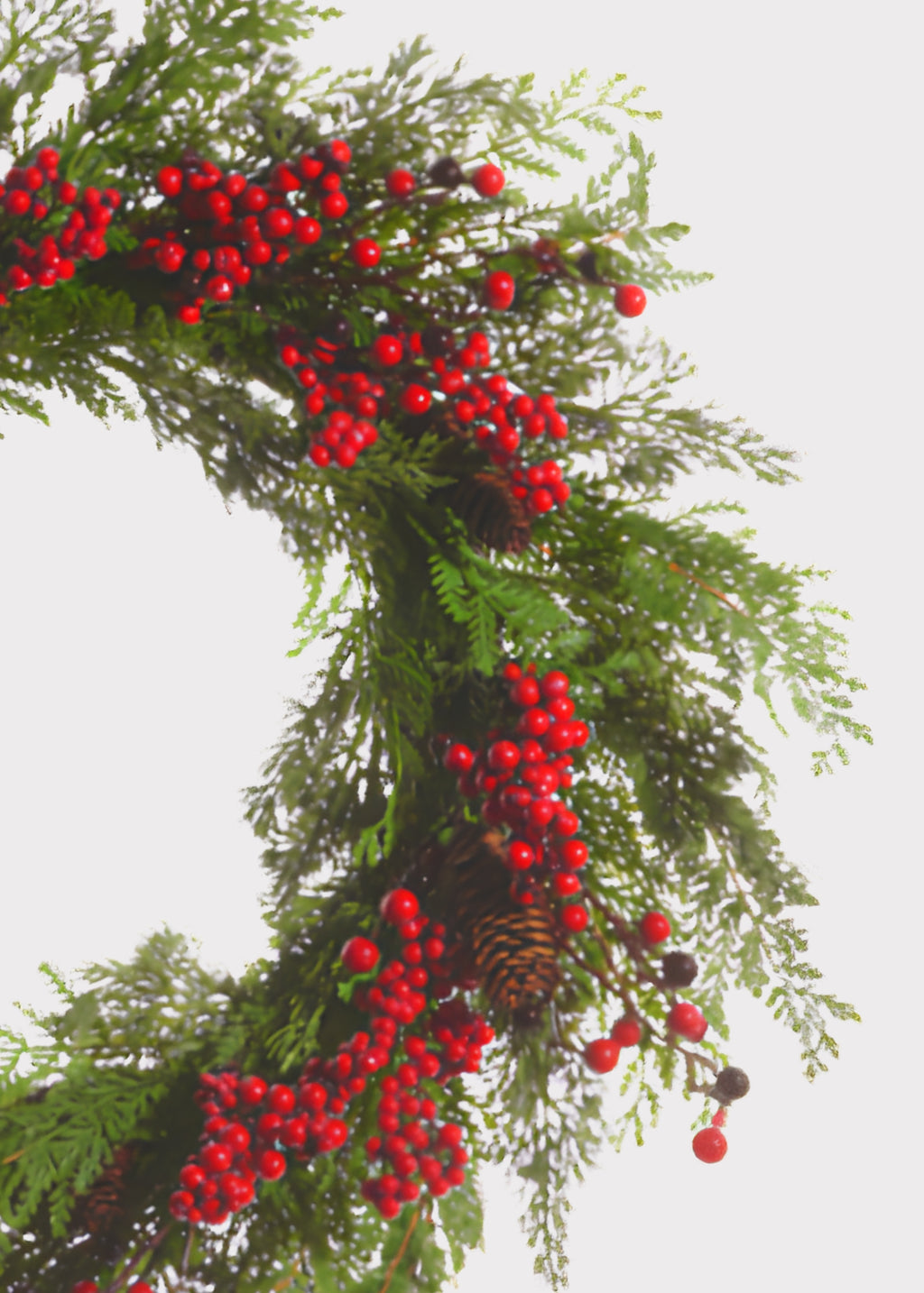 Close-up of cedar wreath with red berries