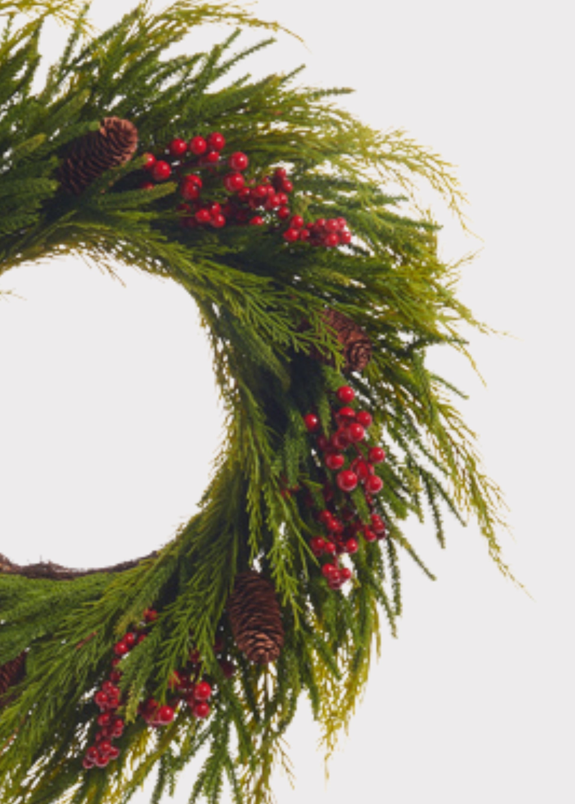 Close-up of Fake Cedar Wreath with Red Berries and Pine Cones 