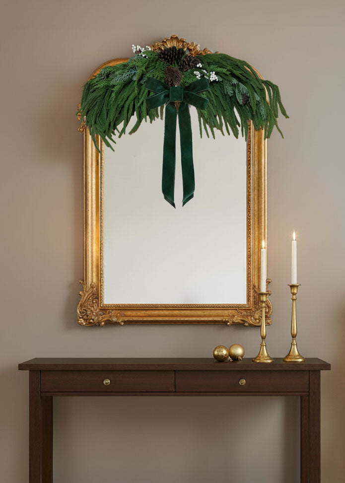 evergreen swag on a mirror with a bow accent