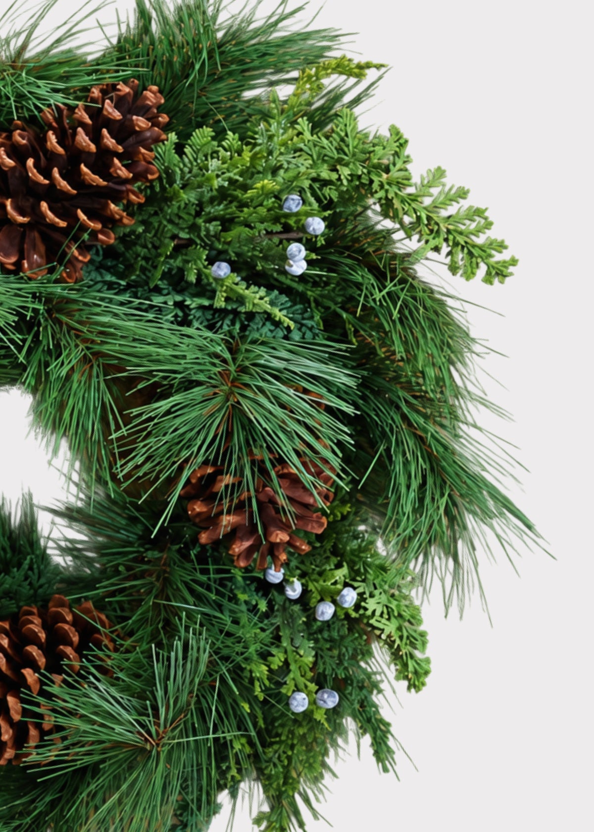 Close-up of Fake Juniper and Pine Cone Winter Wreath