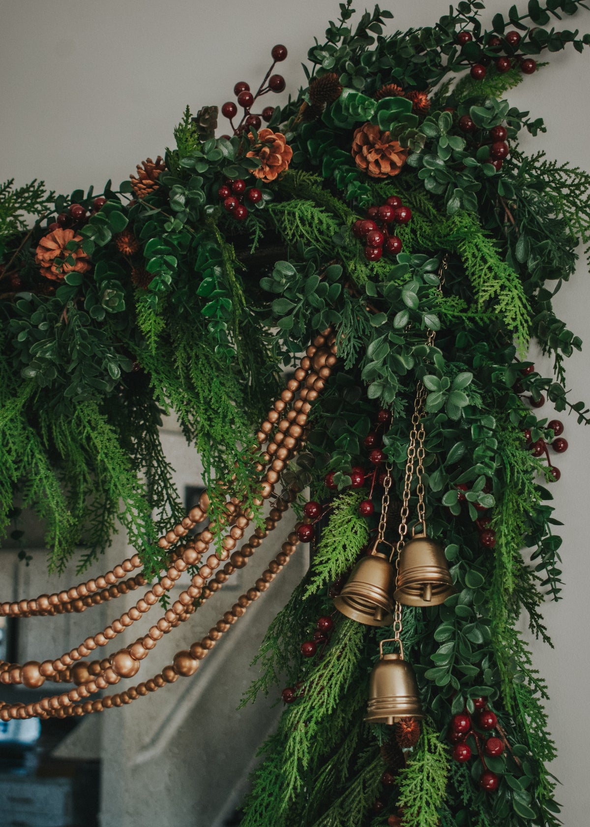 close up of decorative mixed garlands of cedar and eucalyptus and red berries