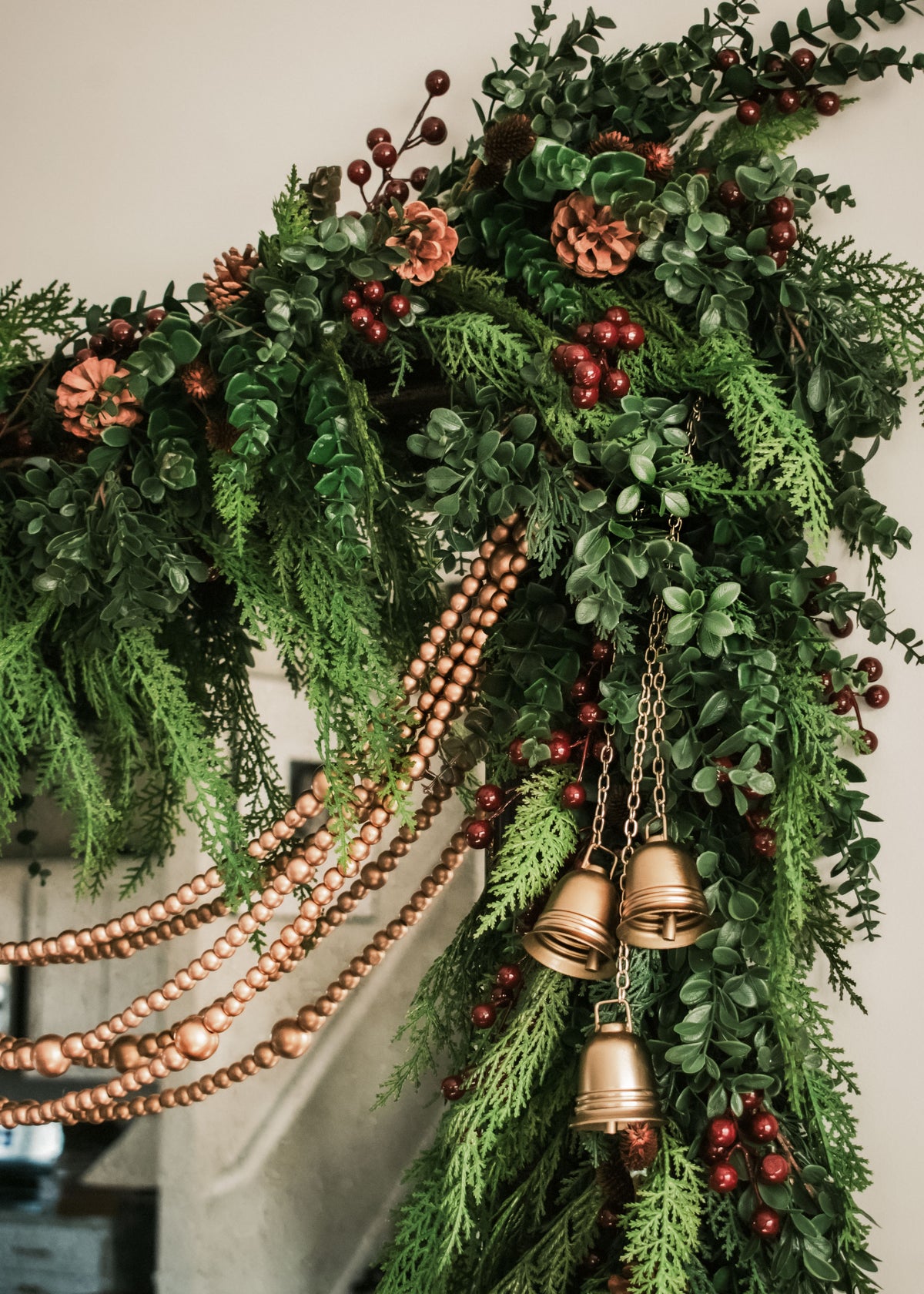 close up of decorative mixed garlands of cedar and eucalyptus and red berries