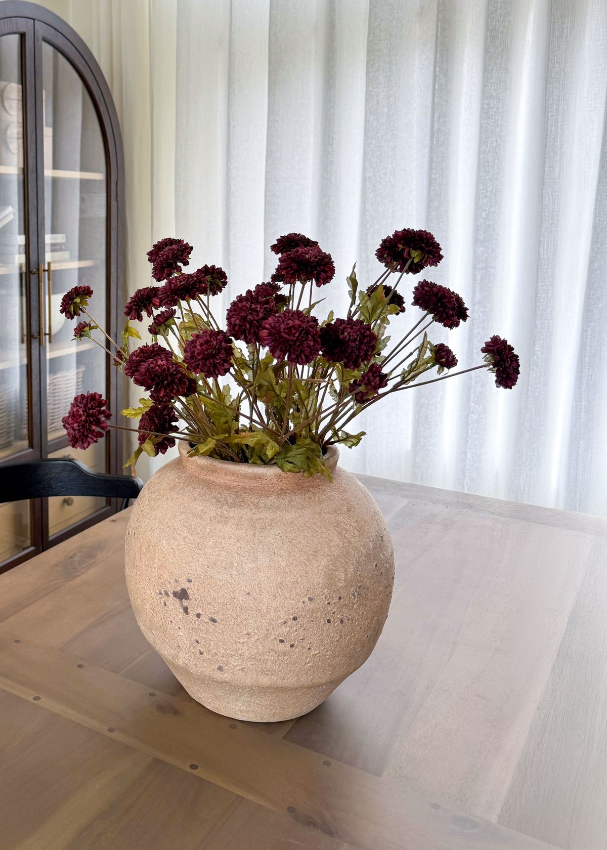 Chocolate Pompom Mums in a stoneware vase
