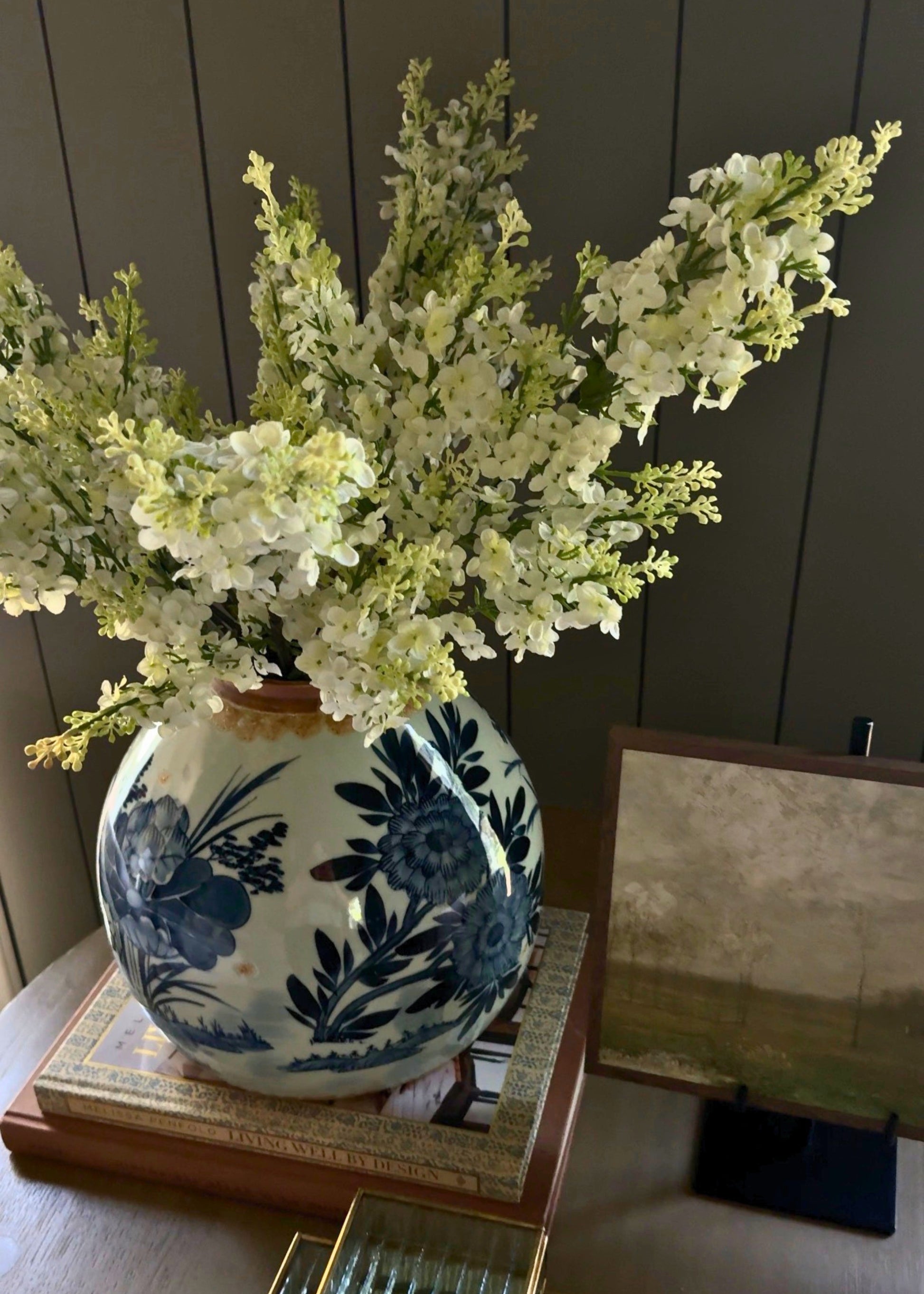 Decorative blue and white gingervase with lilac floral arrangement 