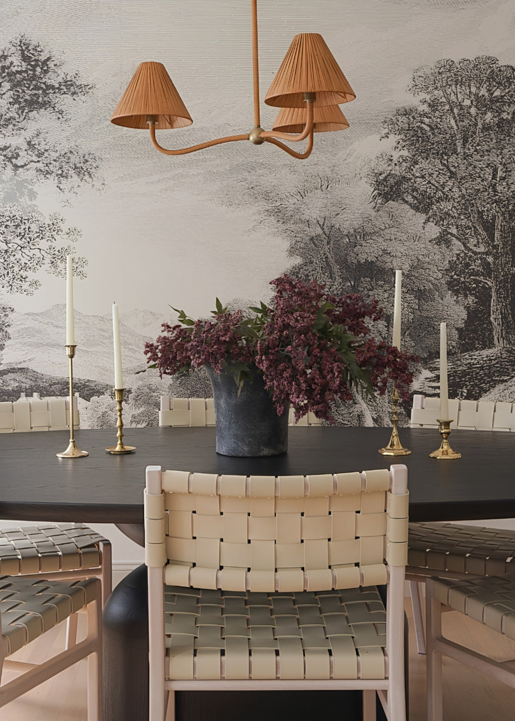 burgundy nandina berry branches arranged in a vase on a dining table