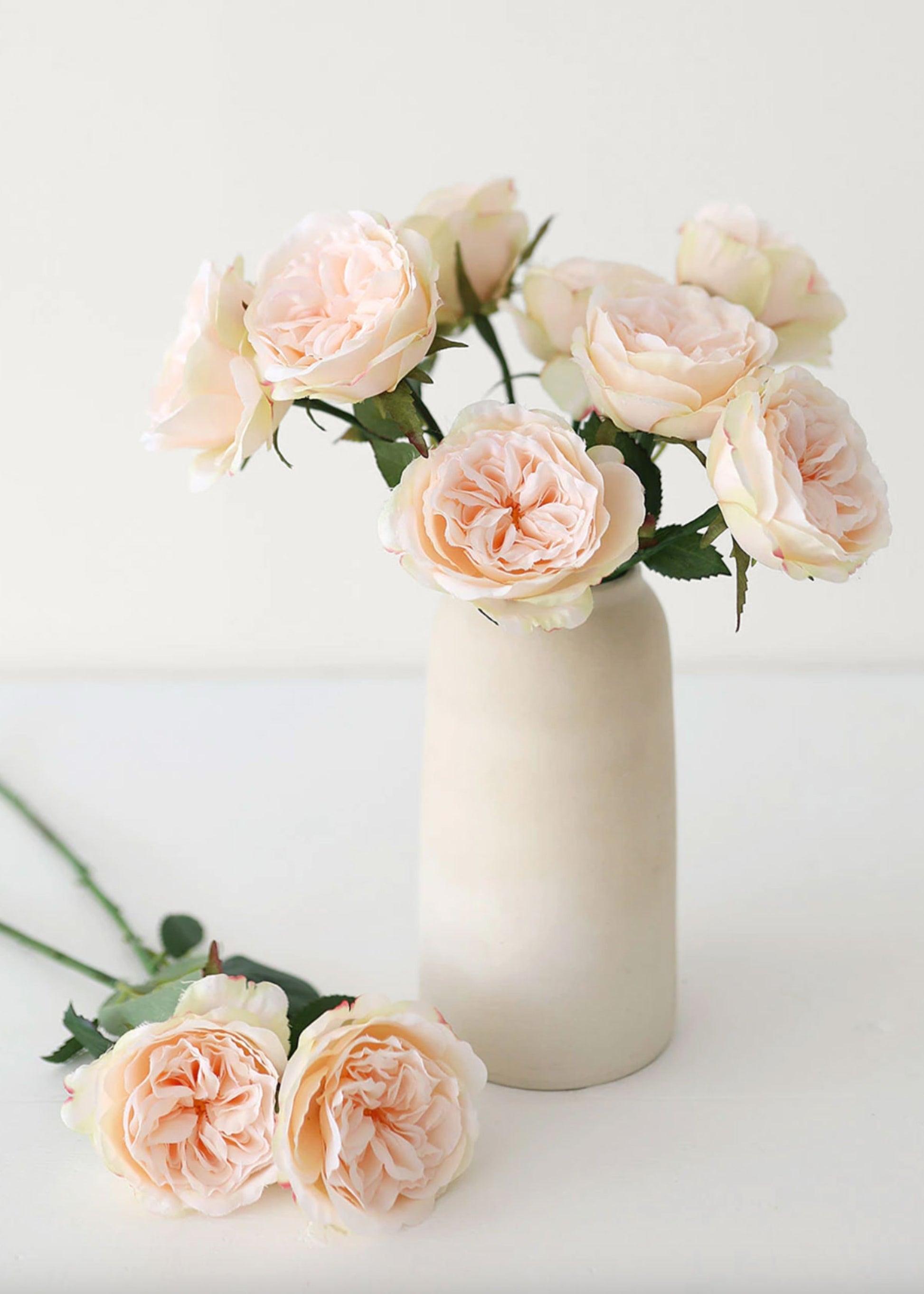 vase of silk apricot rose stems