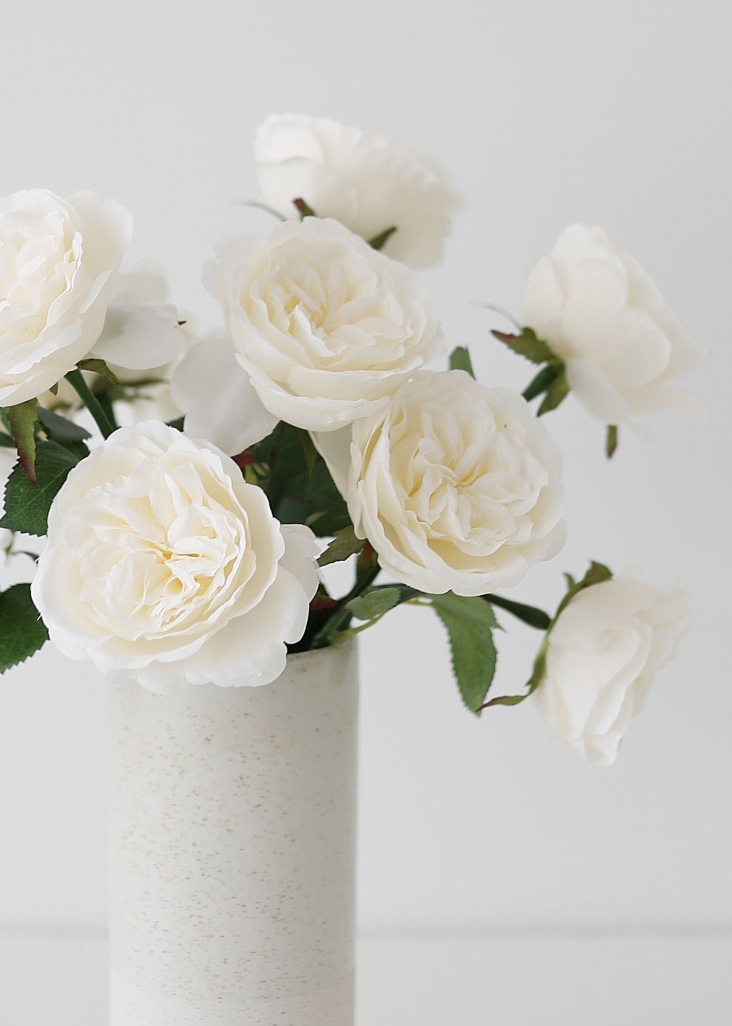 White silk roses in a vase