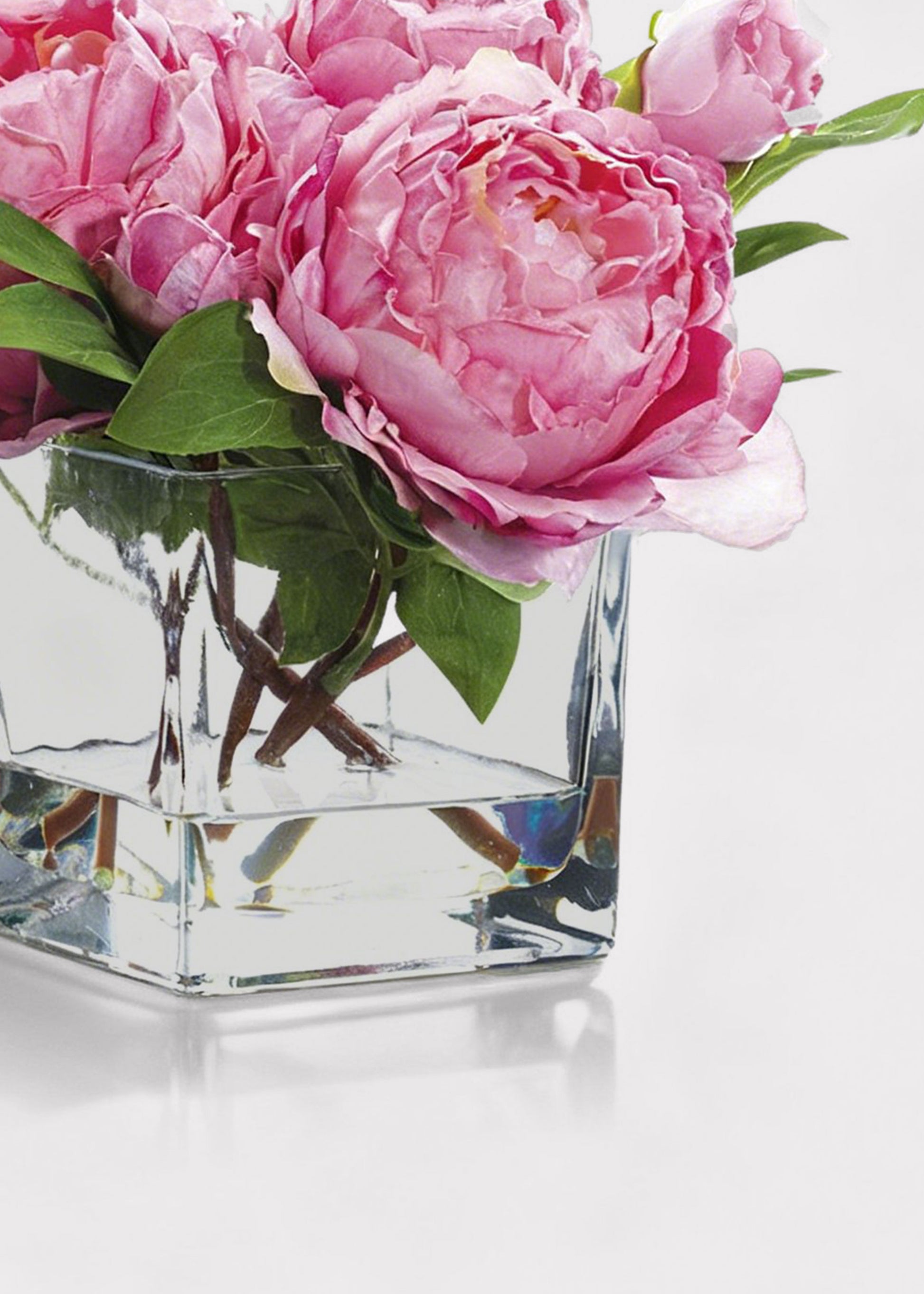 Pink peonies in a clear glass vase 