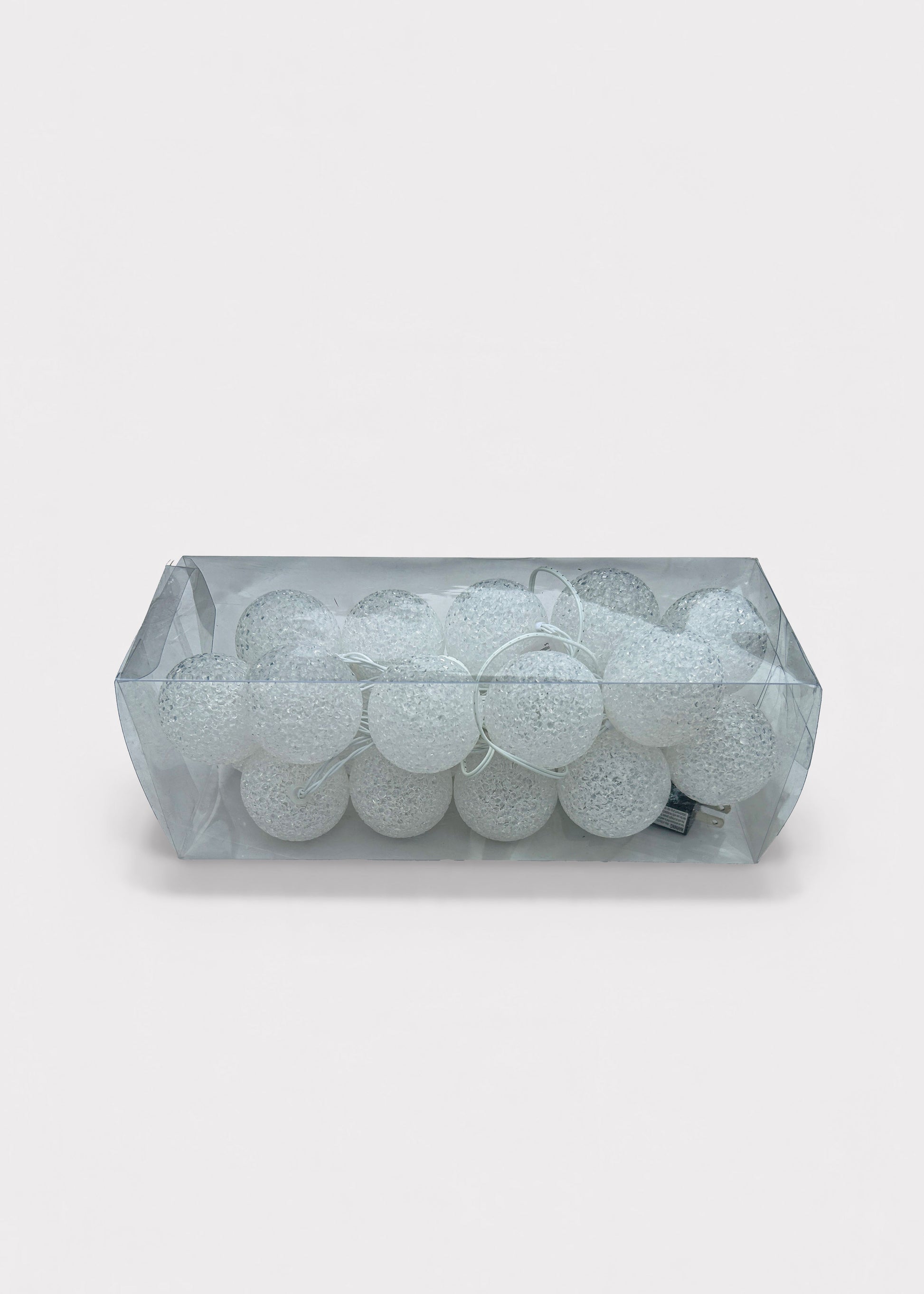 A rectangular clear plastic container filled with Pre-Lit Ball Ornament Garland with White Lights 