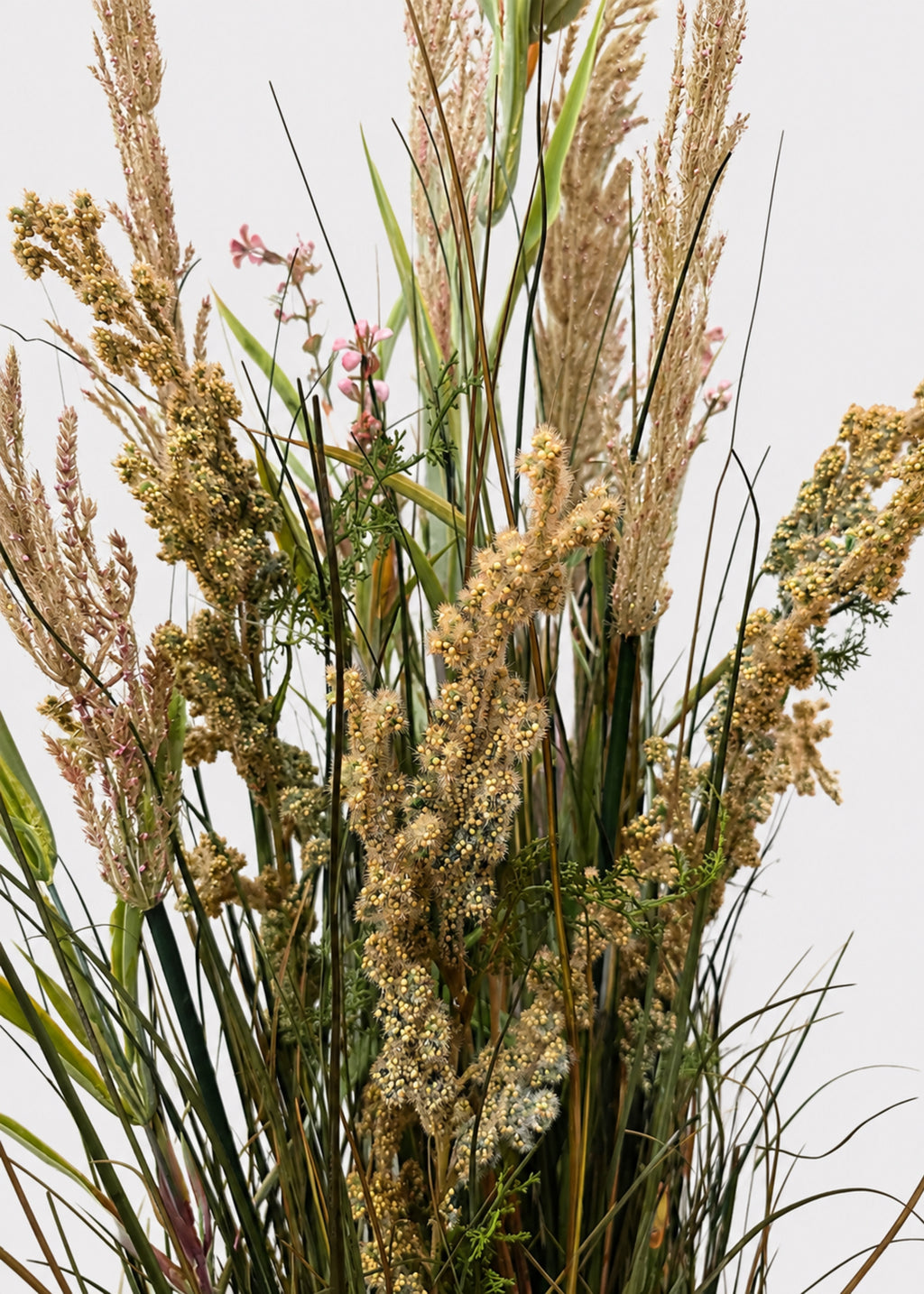 Close-up of a Large Green and Brown Fake Field Grass Potted Plant