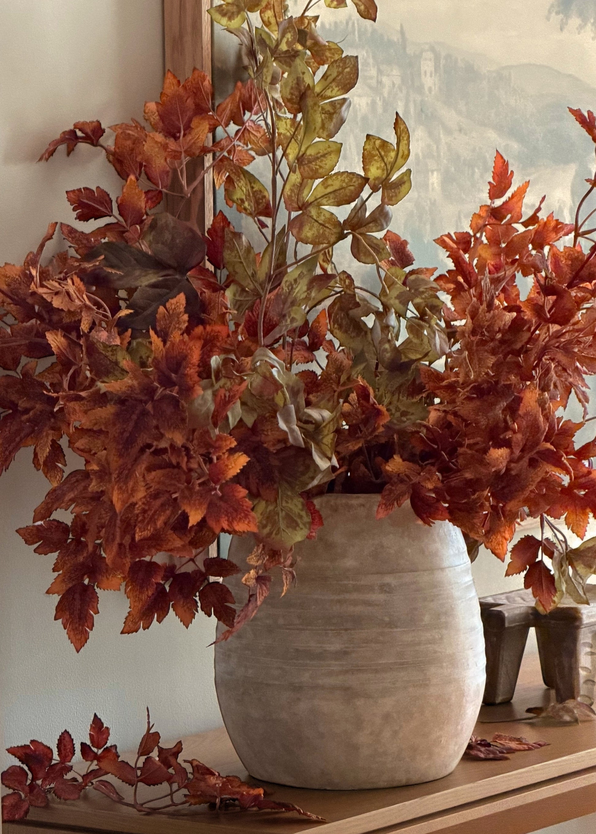 artificial rust brown cimicifuga leaves and grape ivy stems arrangement in a vase