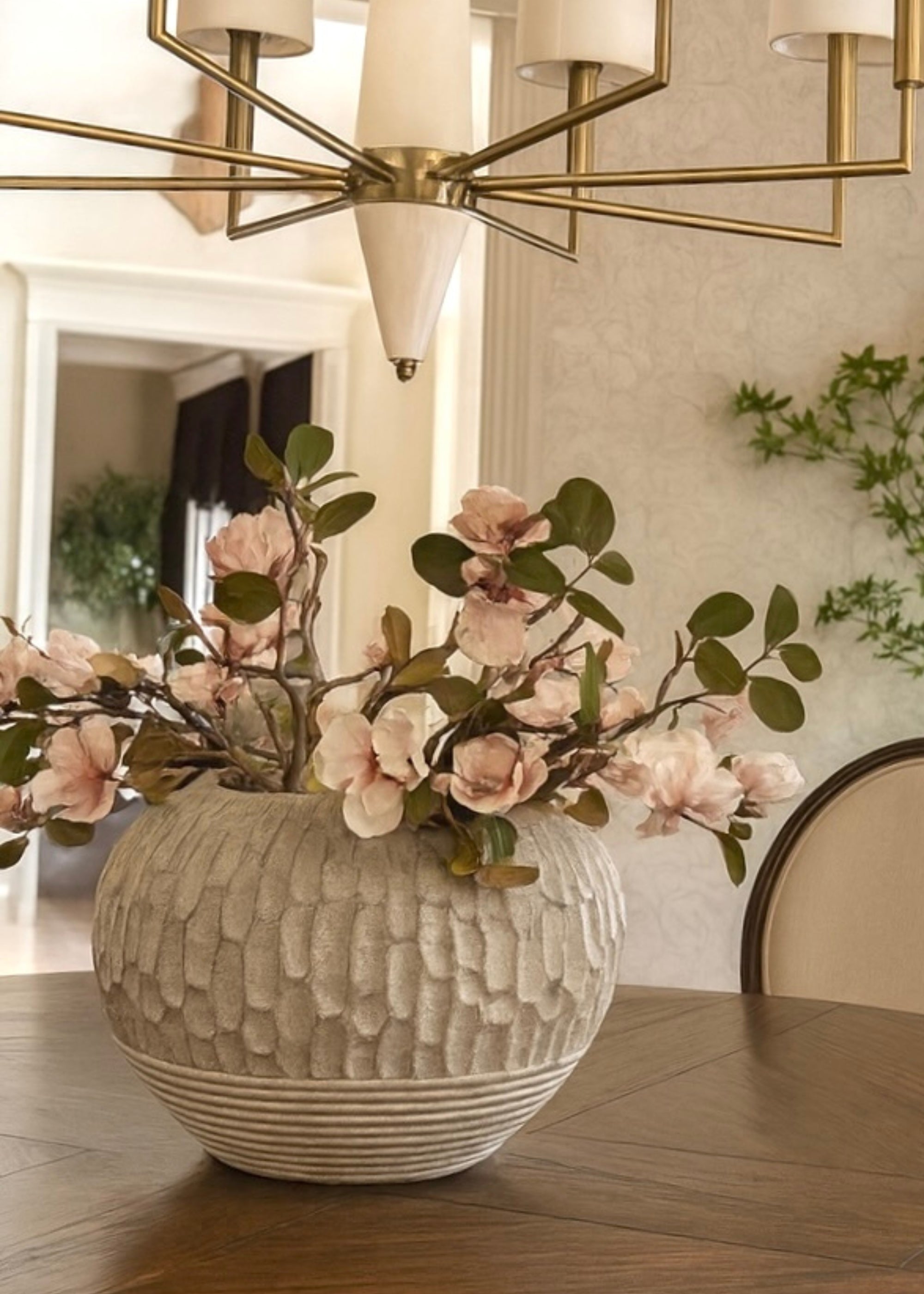 Close-up of faux magnolia flowers in decorative vase