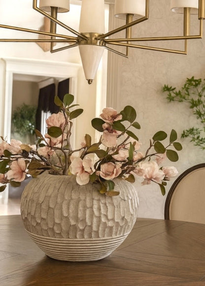 Close-up of faux magnolia flowers in decorative vase