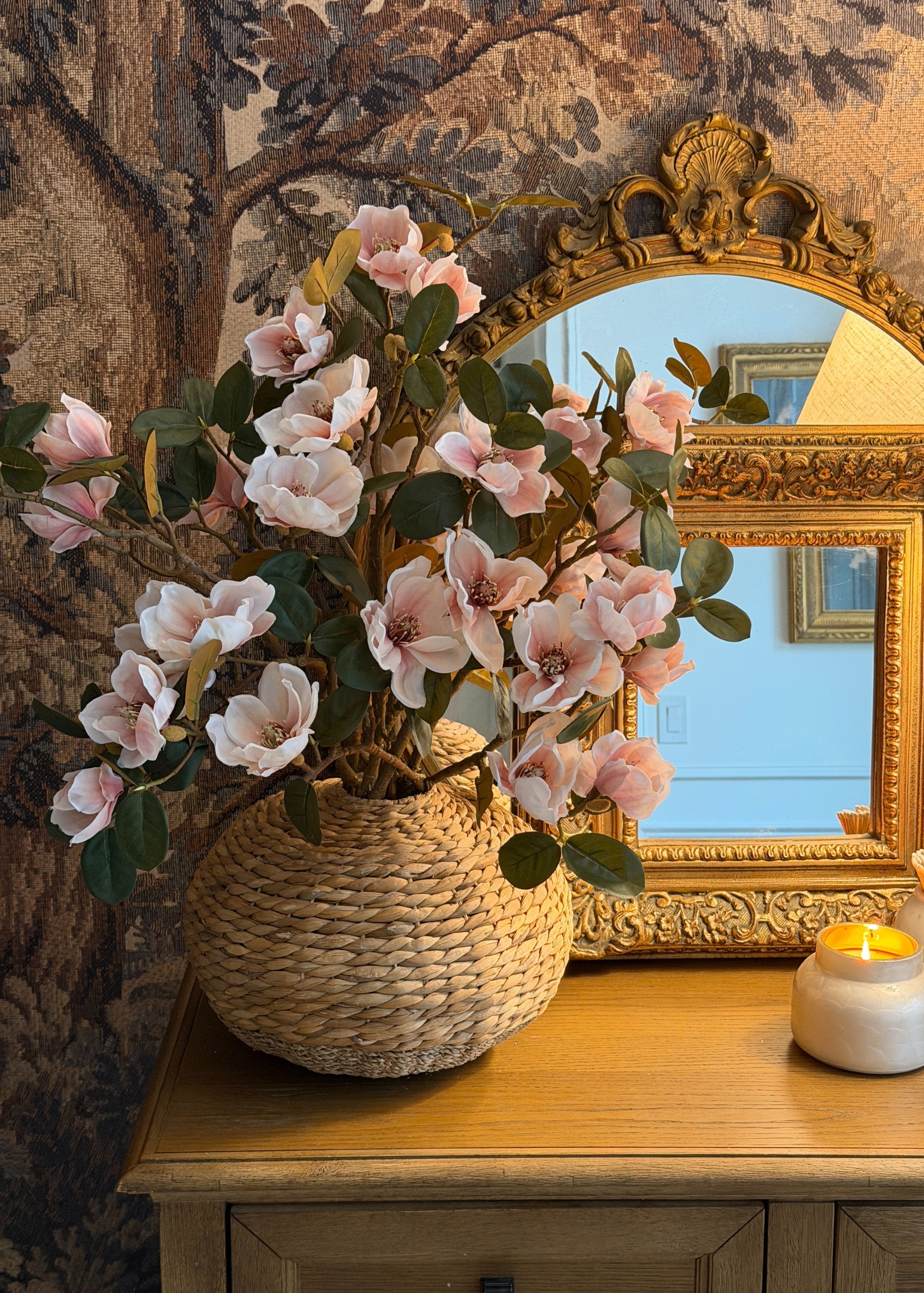 Decorative floral magnolia arrangement in a woven basket 