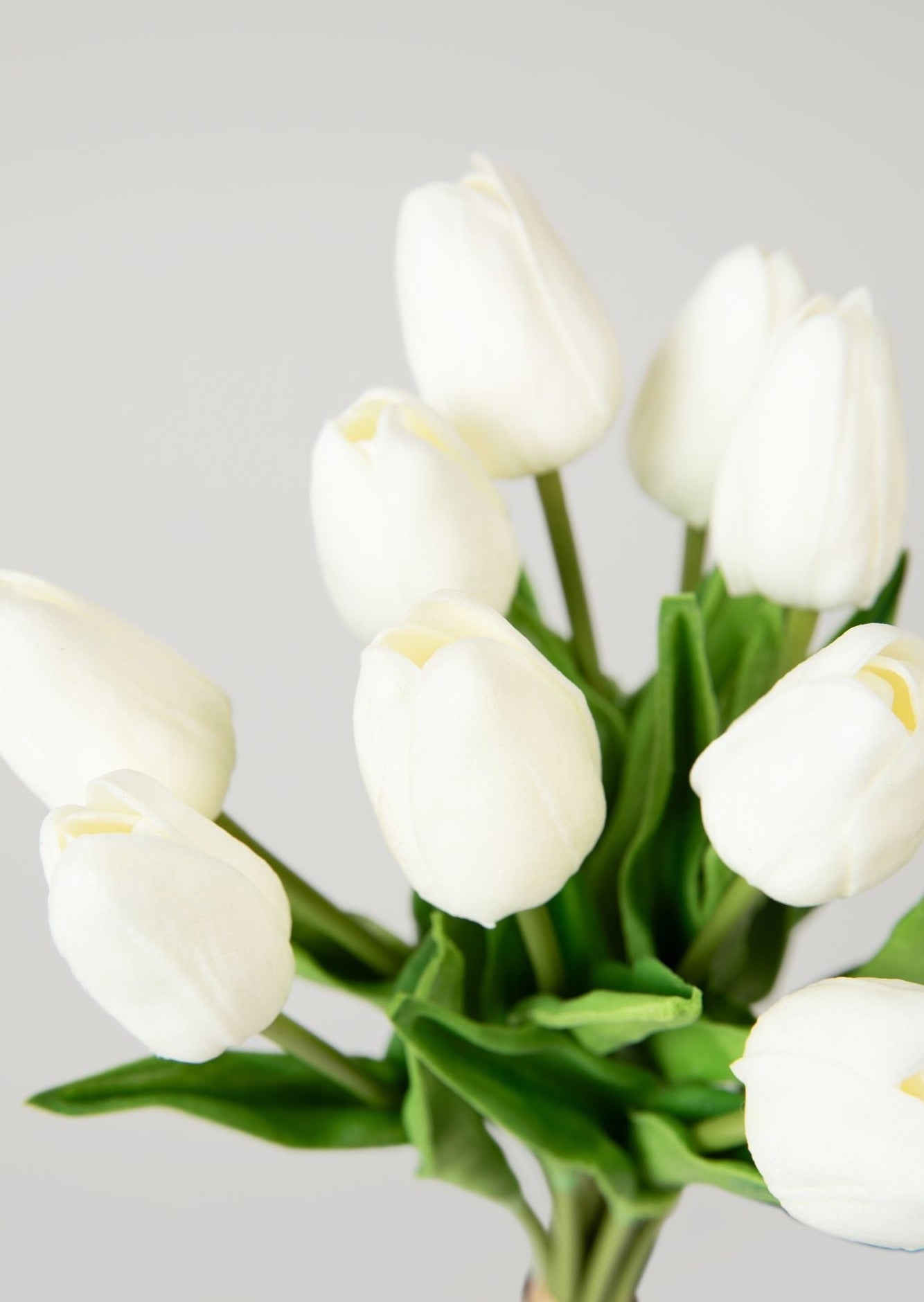 close up of white real touch tulip flower bundle