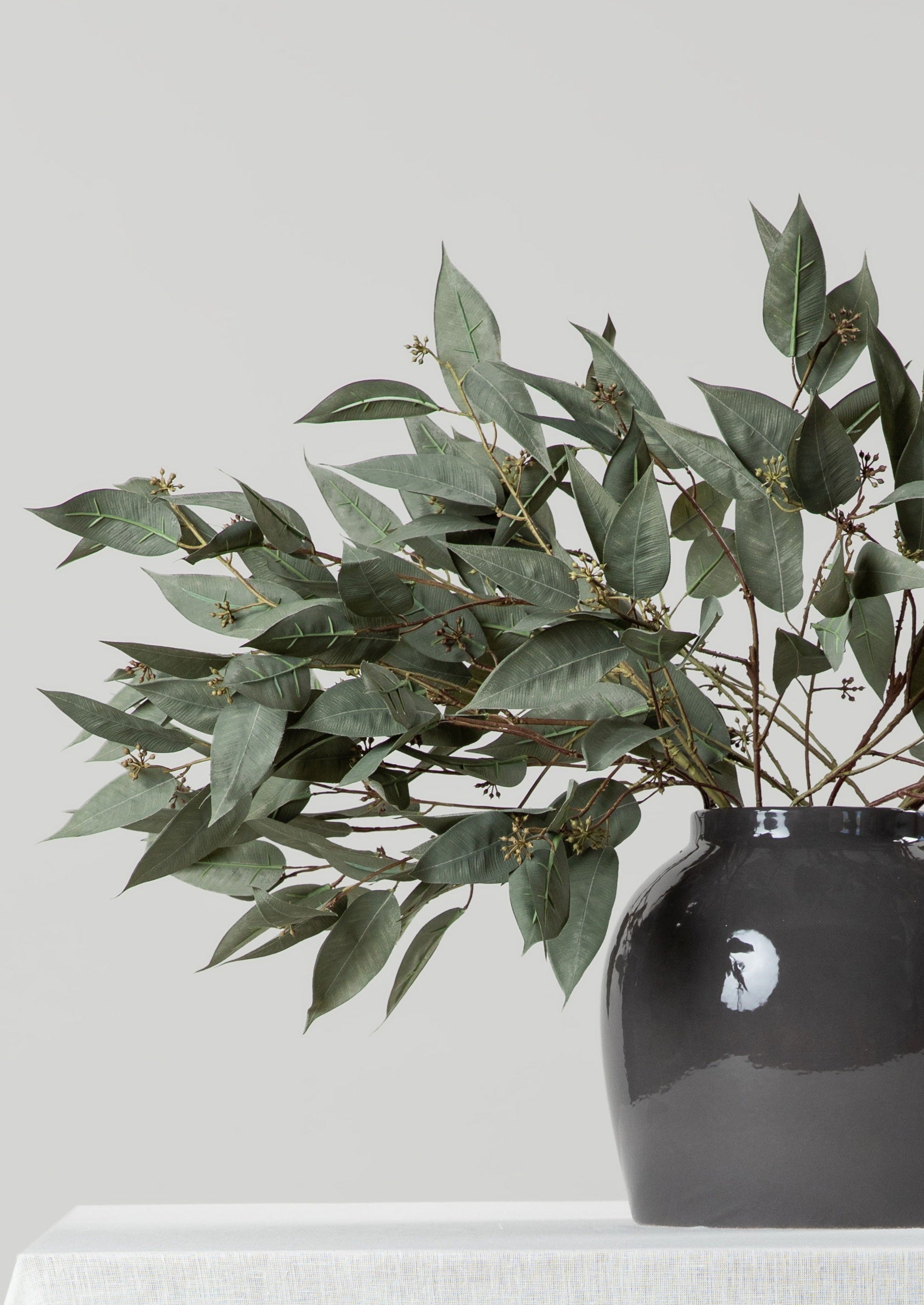 Seeded Eucalyptus Branches Arranged in Smokey Taupe Jug Vase