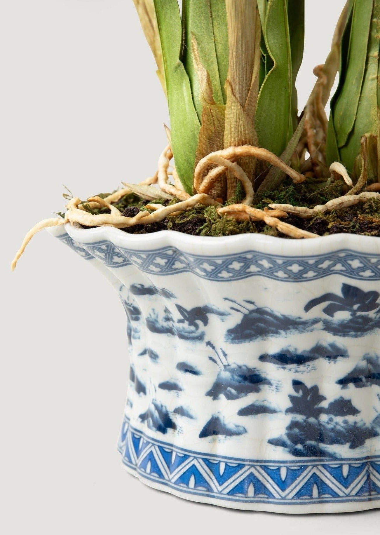 Closeup of Blue and White Ceramic Pot in Faux Orchid Arrangement at Afloral