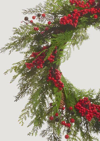 Close-up of cedar wreath with red berries