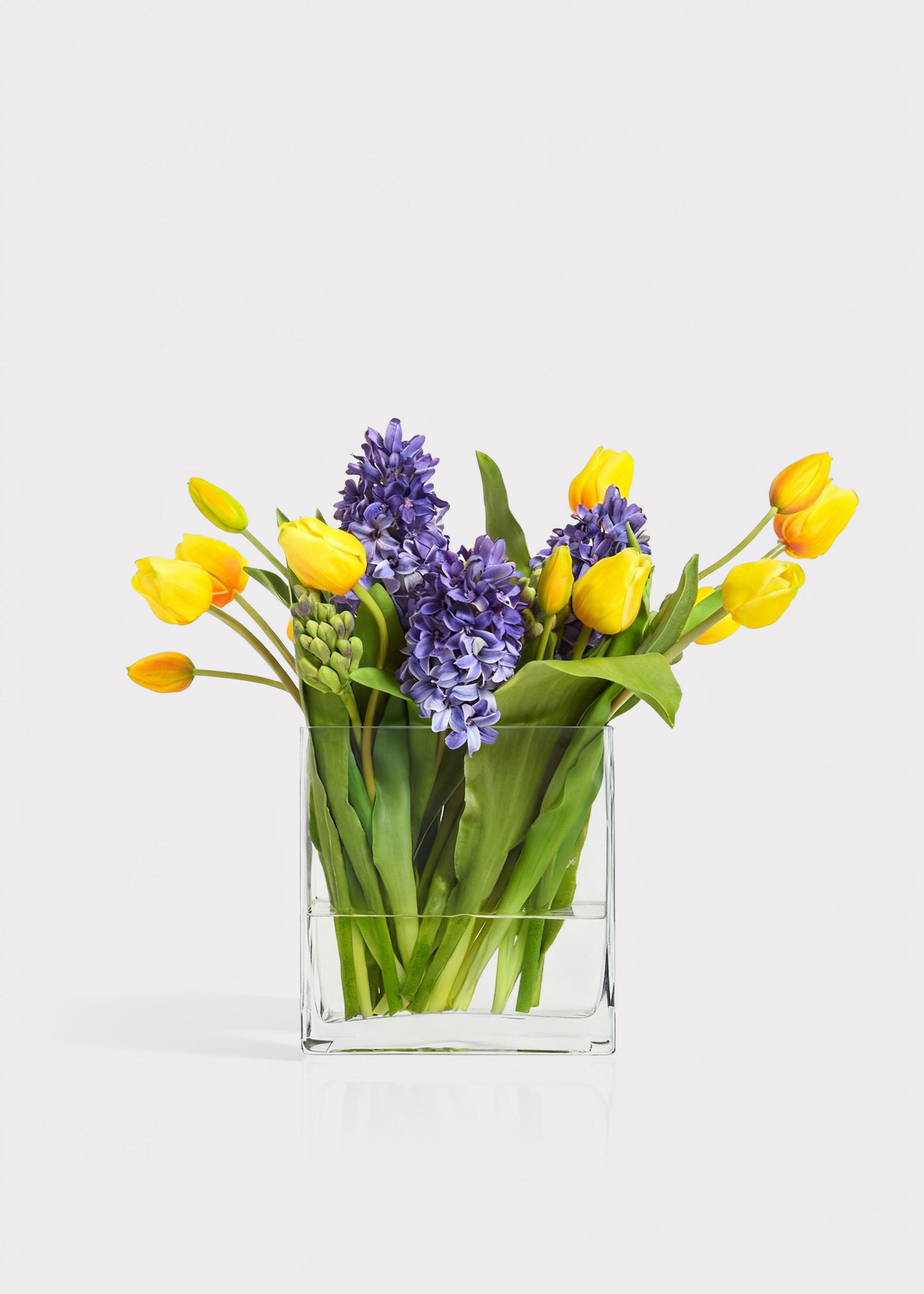 Blue Fake Hyacinth and Yellow Tulip Arrangement in Glass Vase 