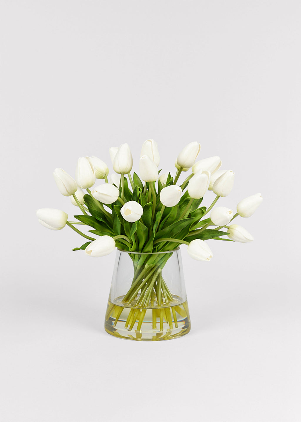 Clear glass vase with white real touch tulips 
