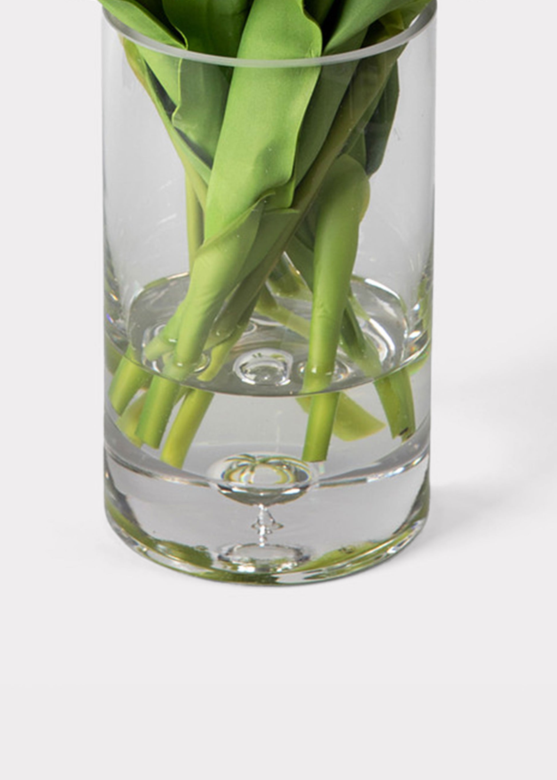 Clear glass vase with acrylic water and tulips stems