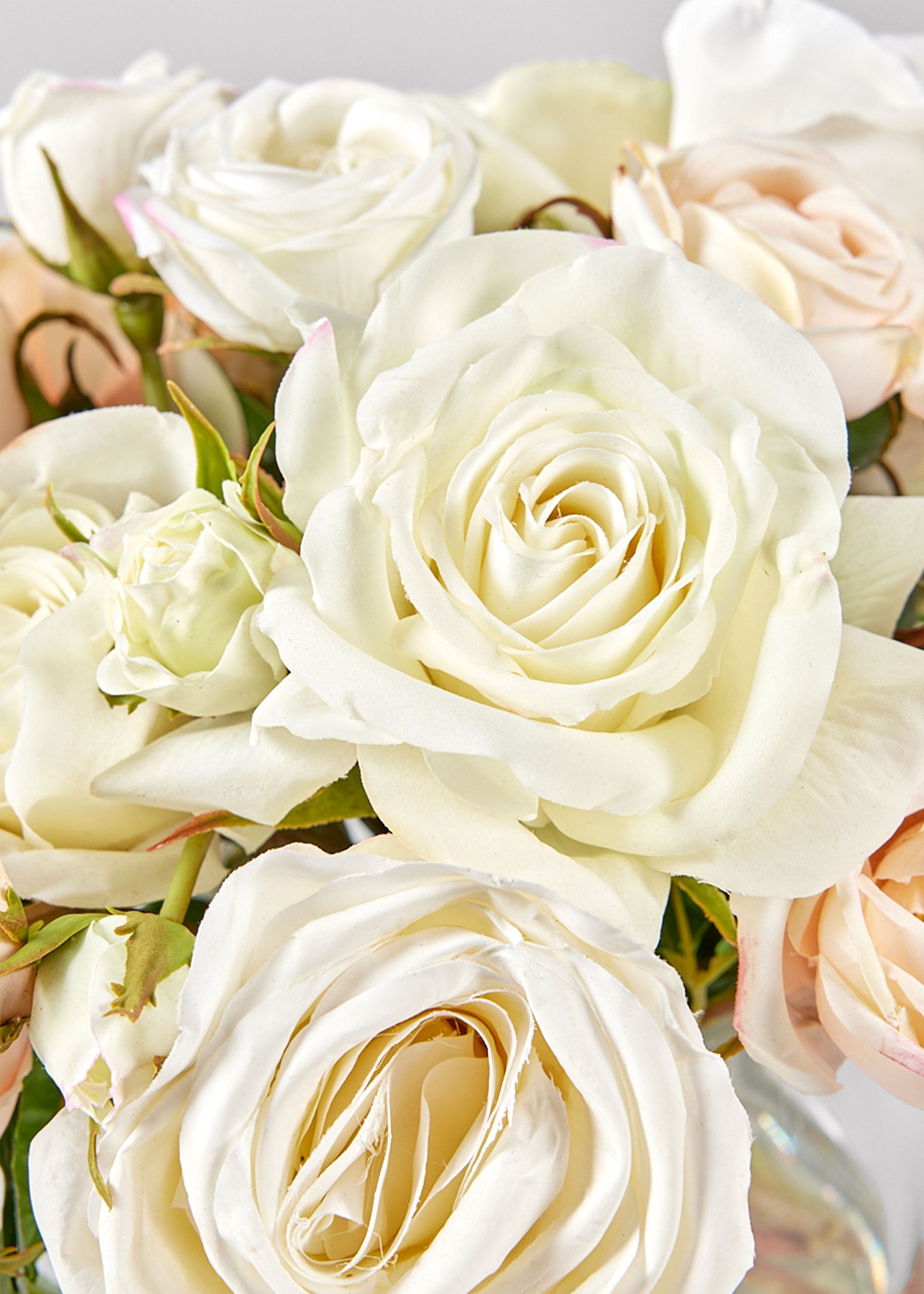 Close-up of a bouquet of white and light pink roses.