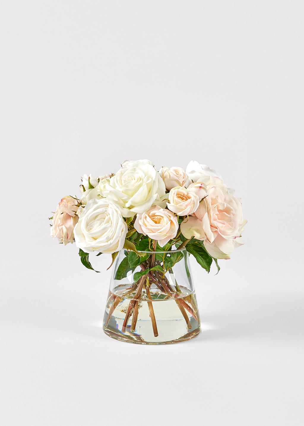Glass vase with white and pink roses 