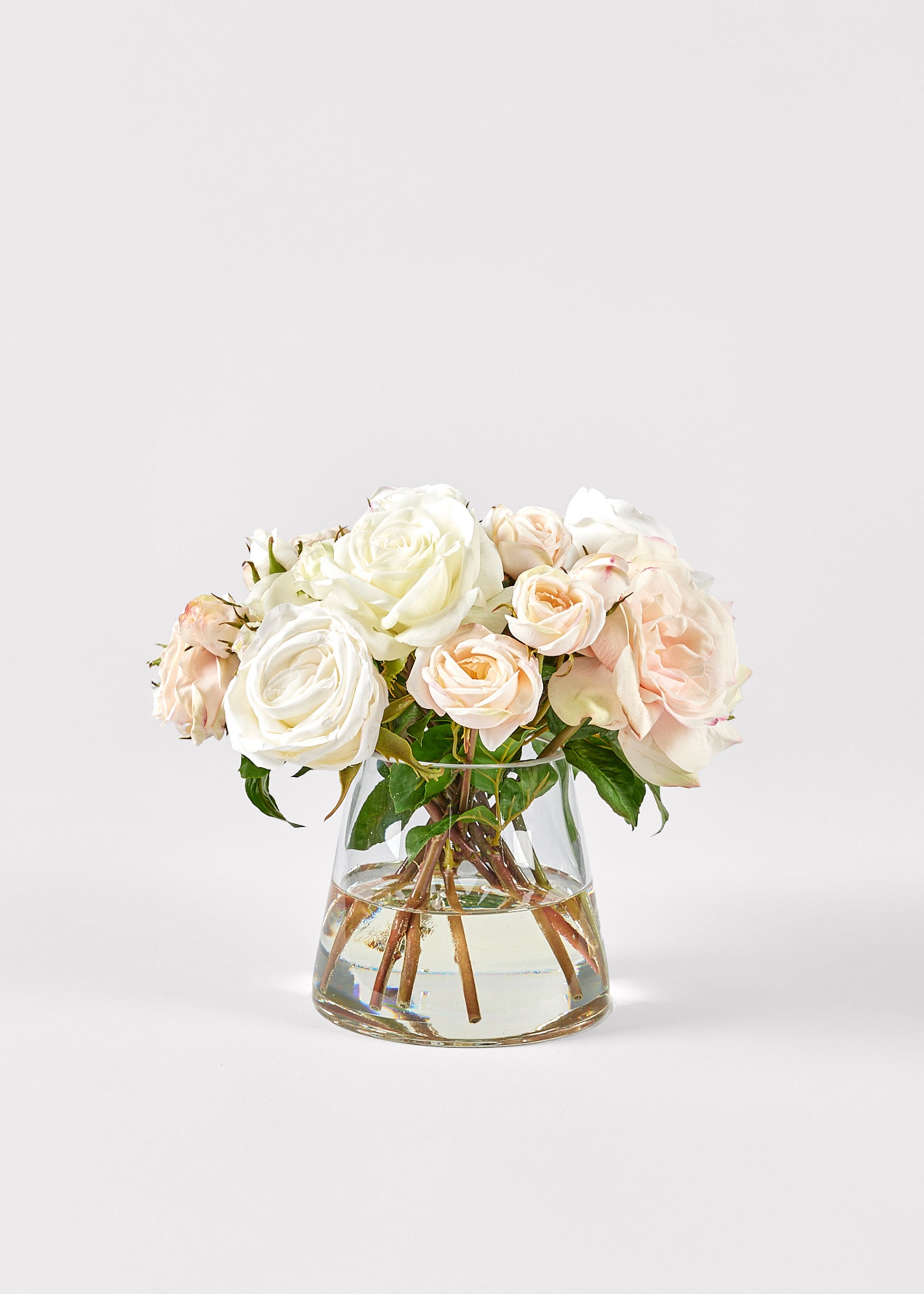 Glass vase with white and pink roses 