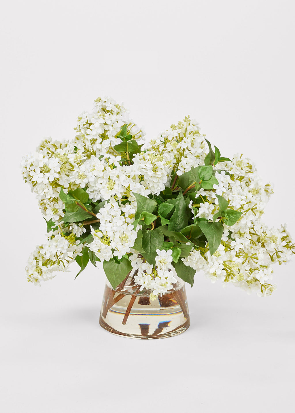 Faux Flower Arrangement of White Lilacs in Glass Vase at Afloral