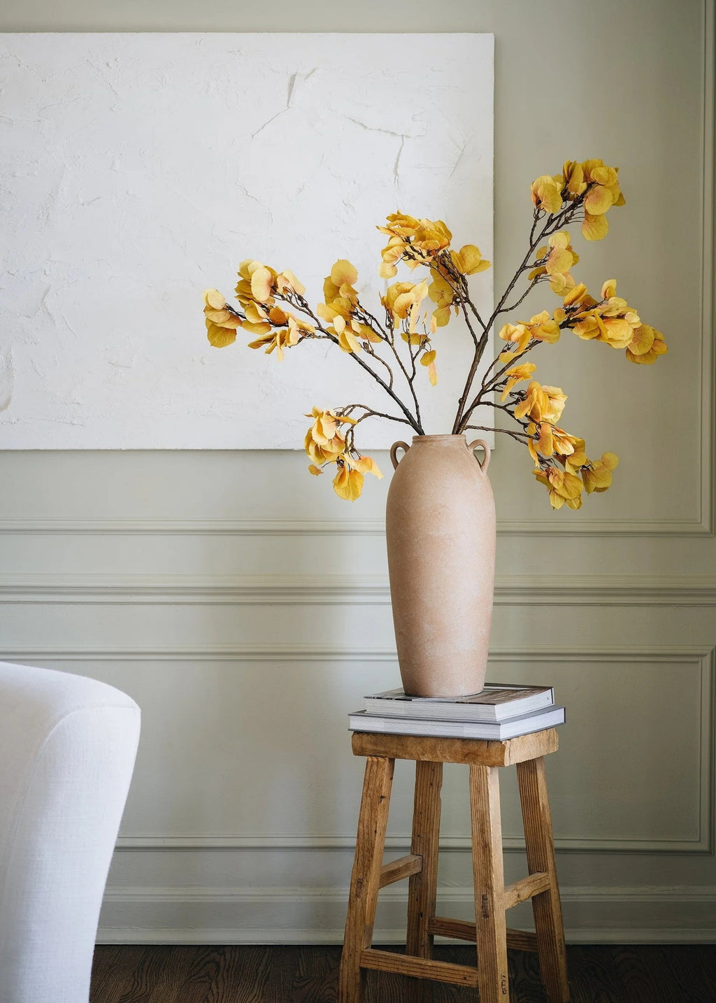 artificial aspen branch in a tall vase