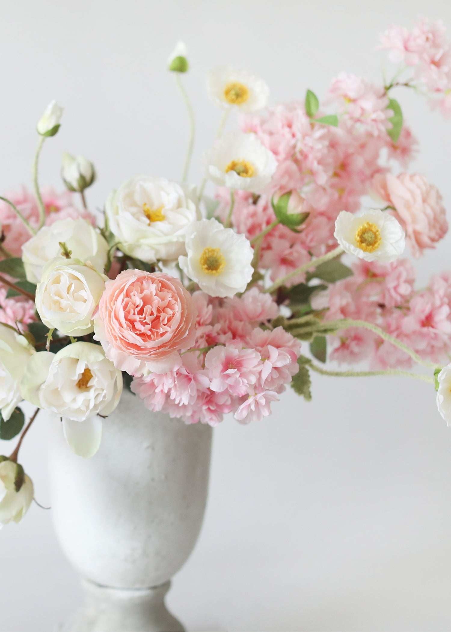 faux poppy and cherry blossom flower arrangement
