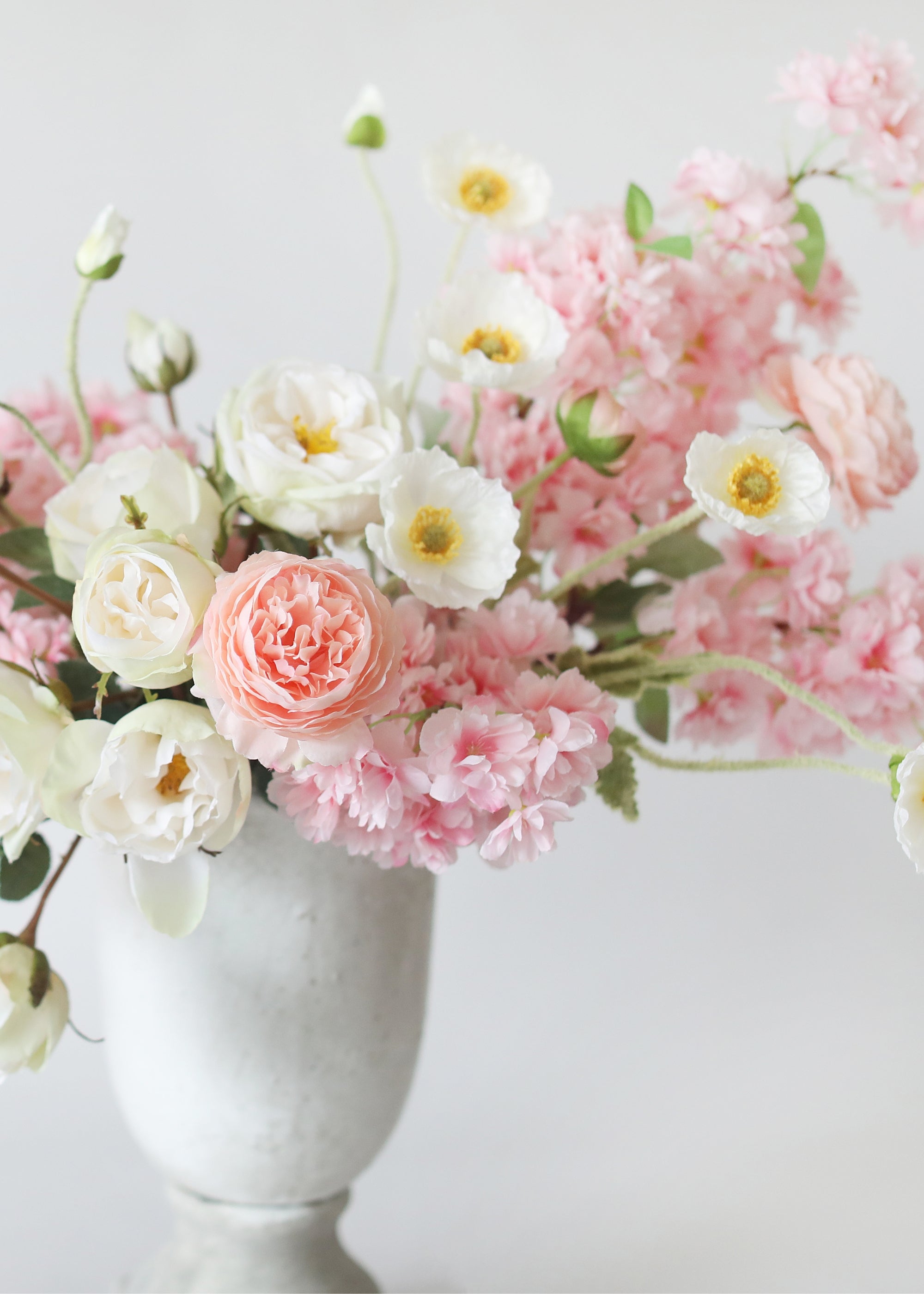 faux poppy and cherry blossom flower arrangement