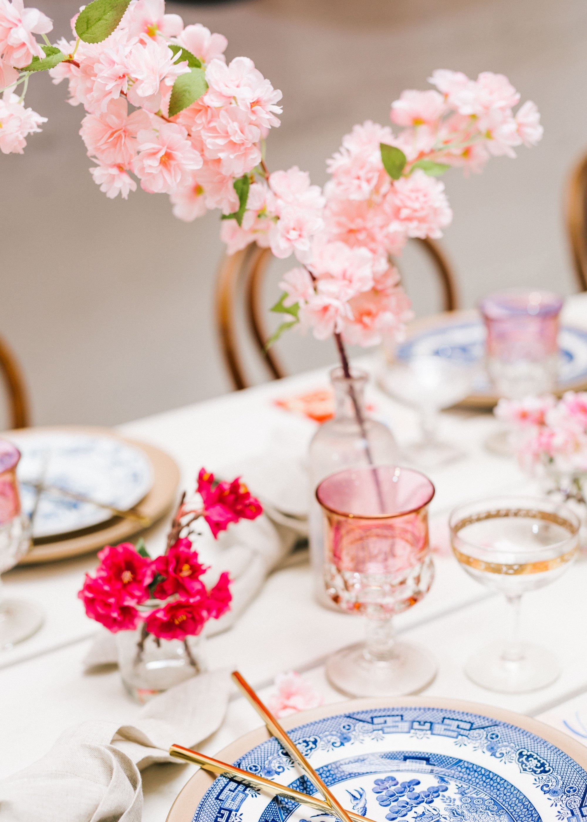 faux cherry blossoms arranged on styled tablescape