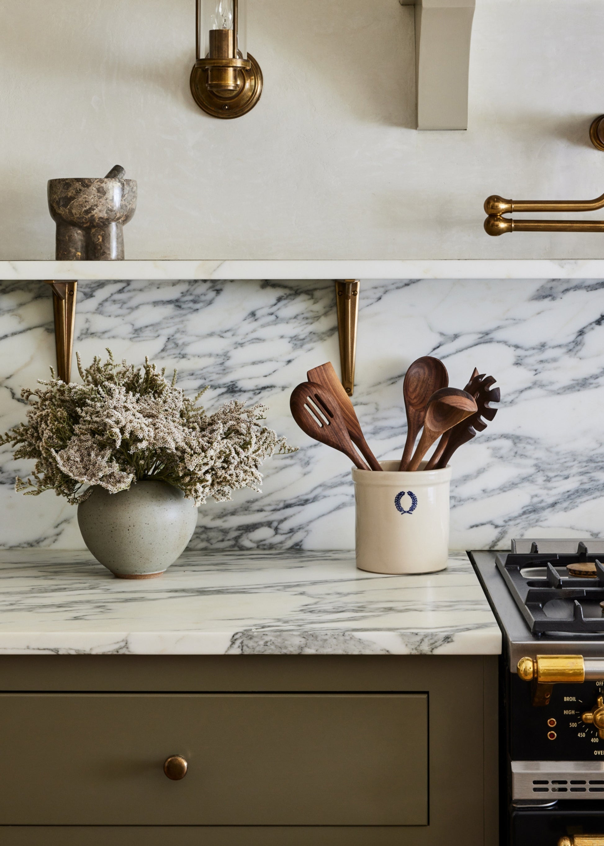 kitchen counter with handmade crock filled with wooden spoons