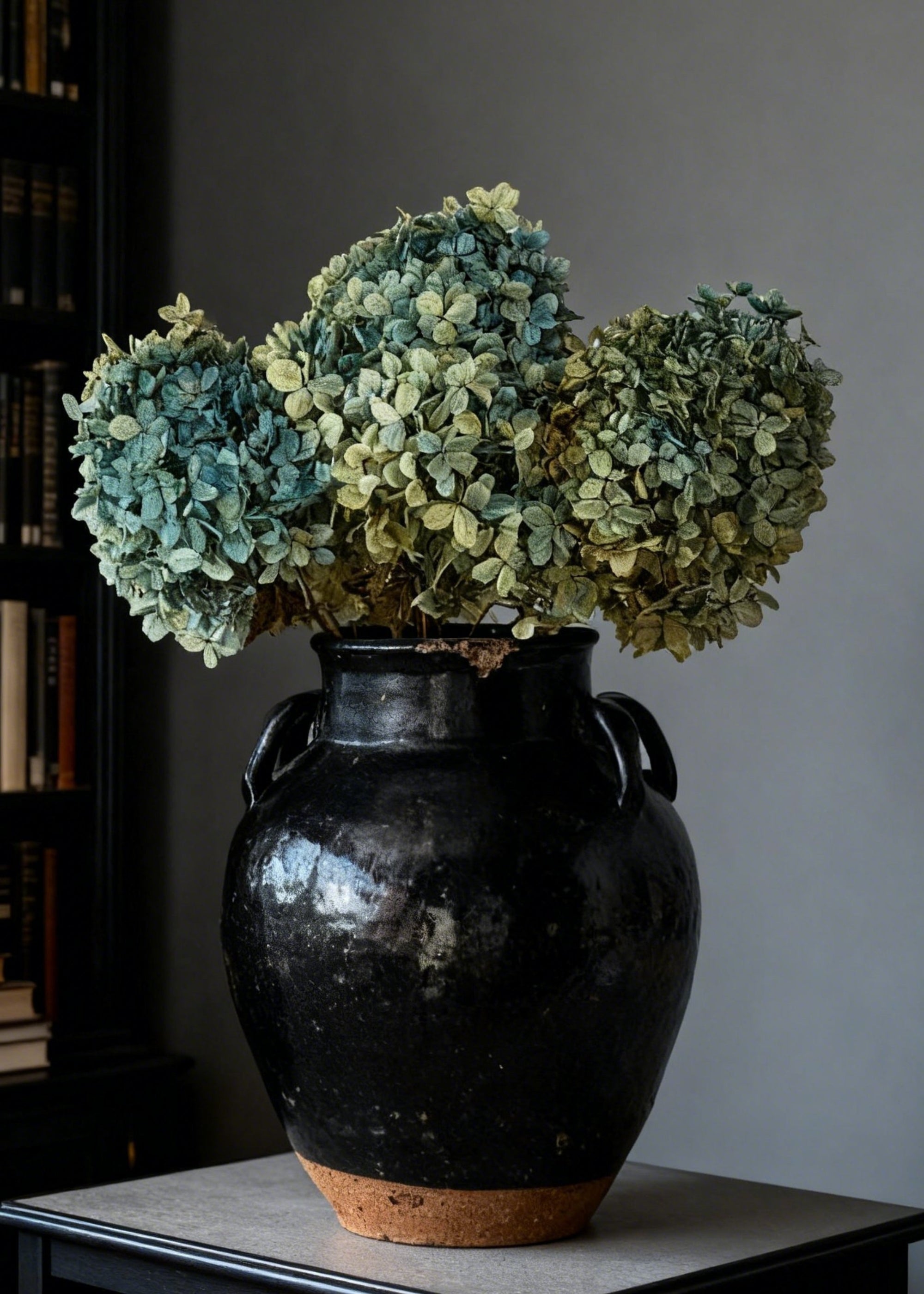dried blue hydrangeas in black vase