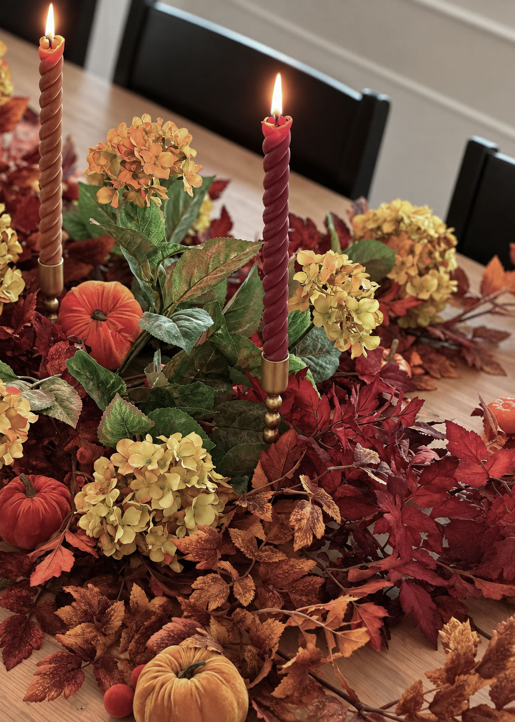 fall table runner with twisted wax candles, hydrangeas, pumpkins and cimicifuga