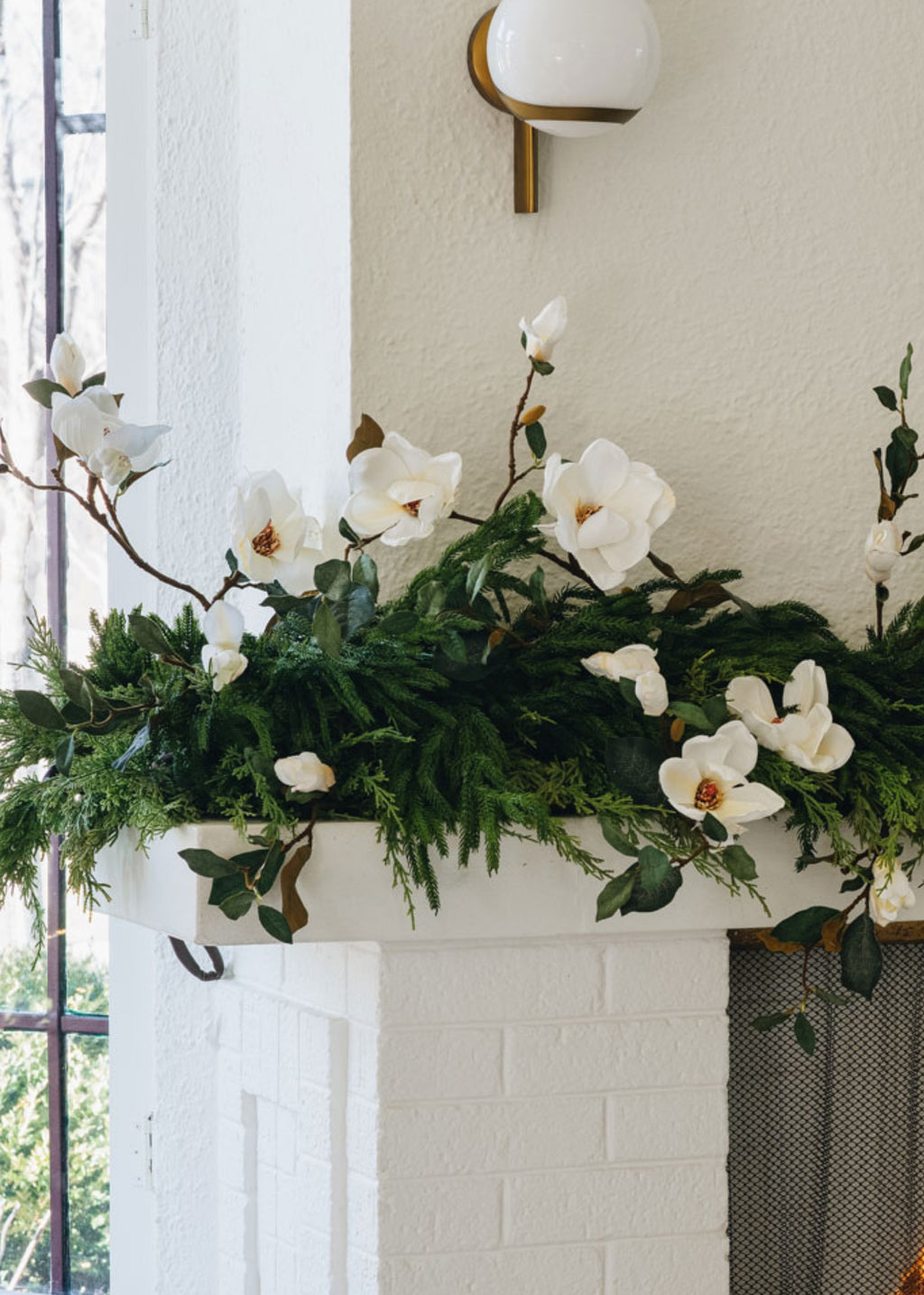 faux magnolia branches styled with afloral norfolk pine and lebanon cedar garlands