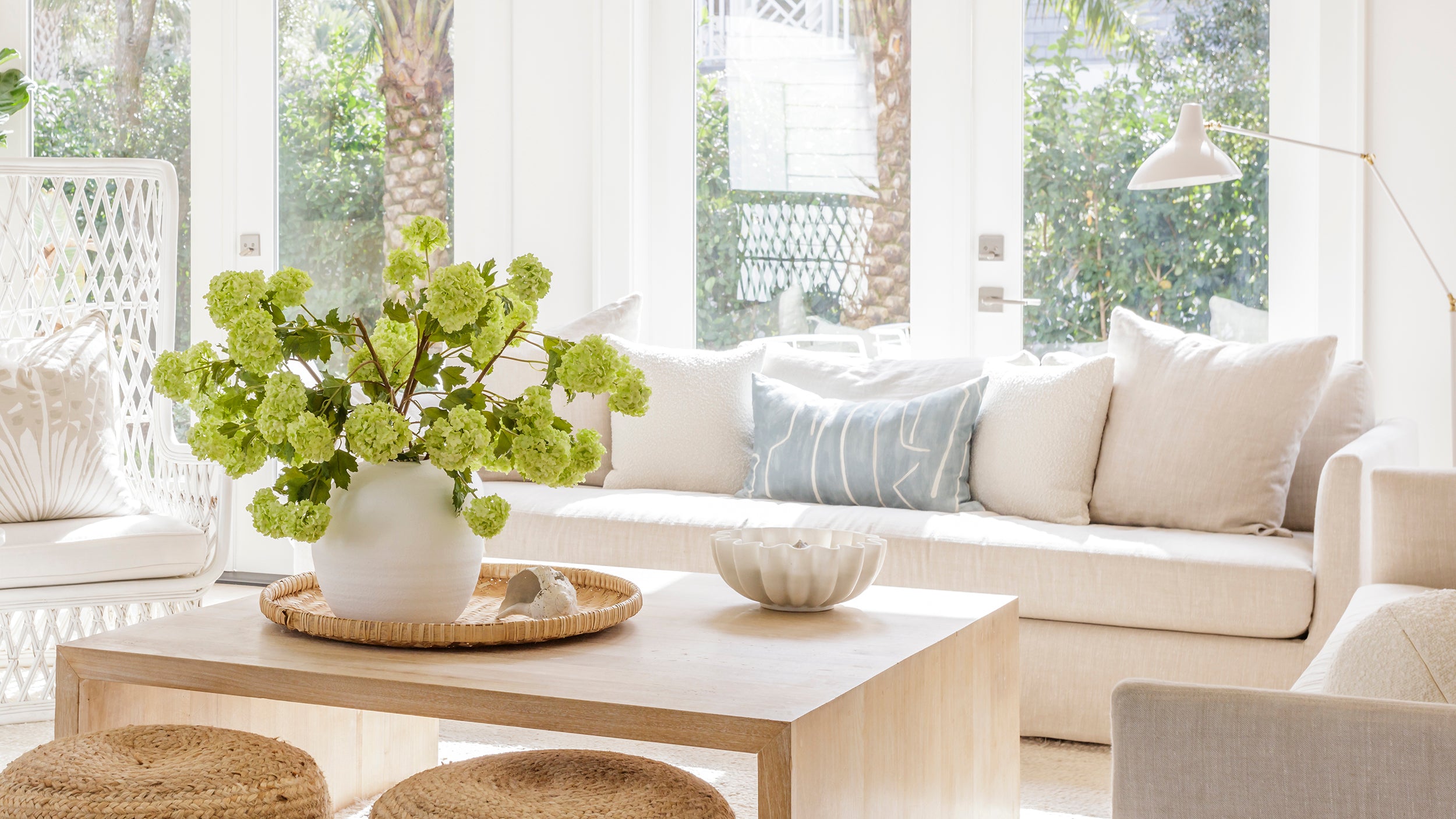Modern living room with a white sofa, coffee table, and decorative elements.