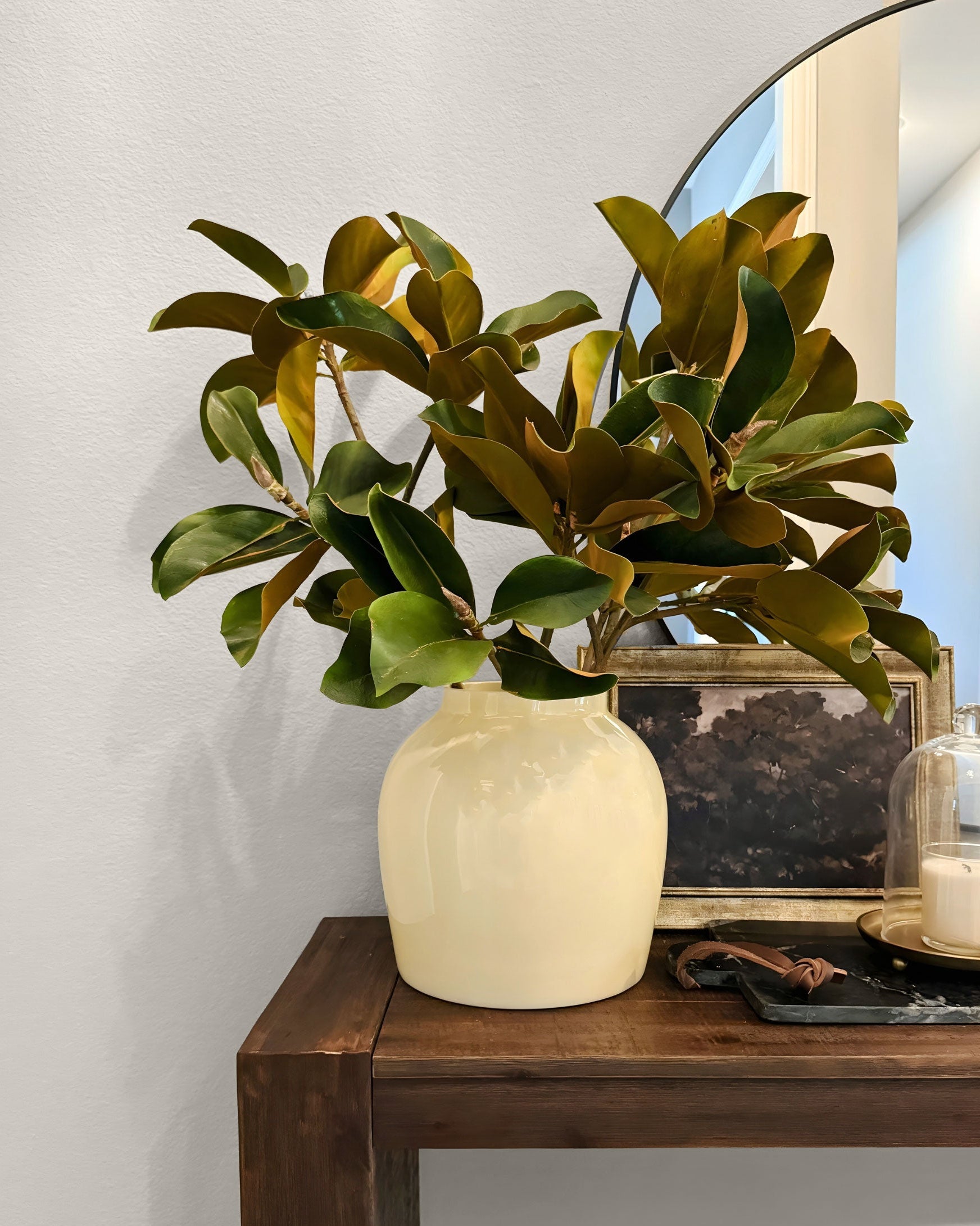 magnolia plant in vase on side table
