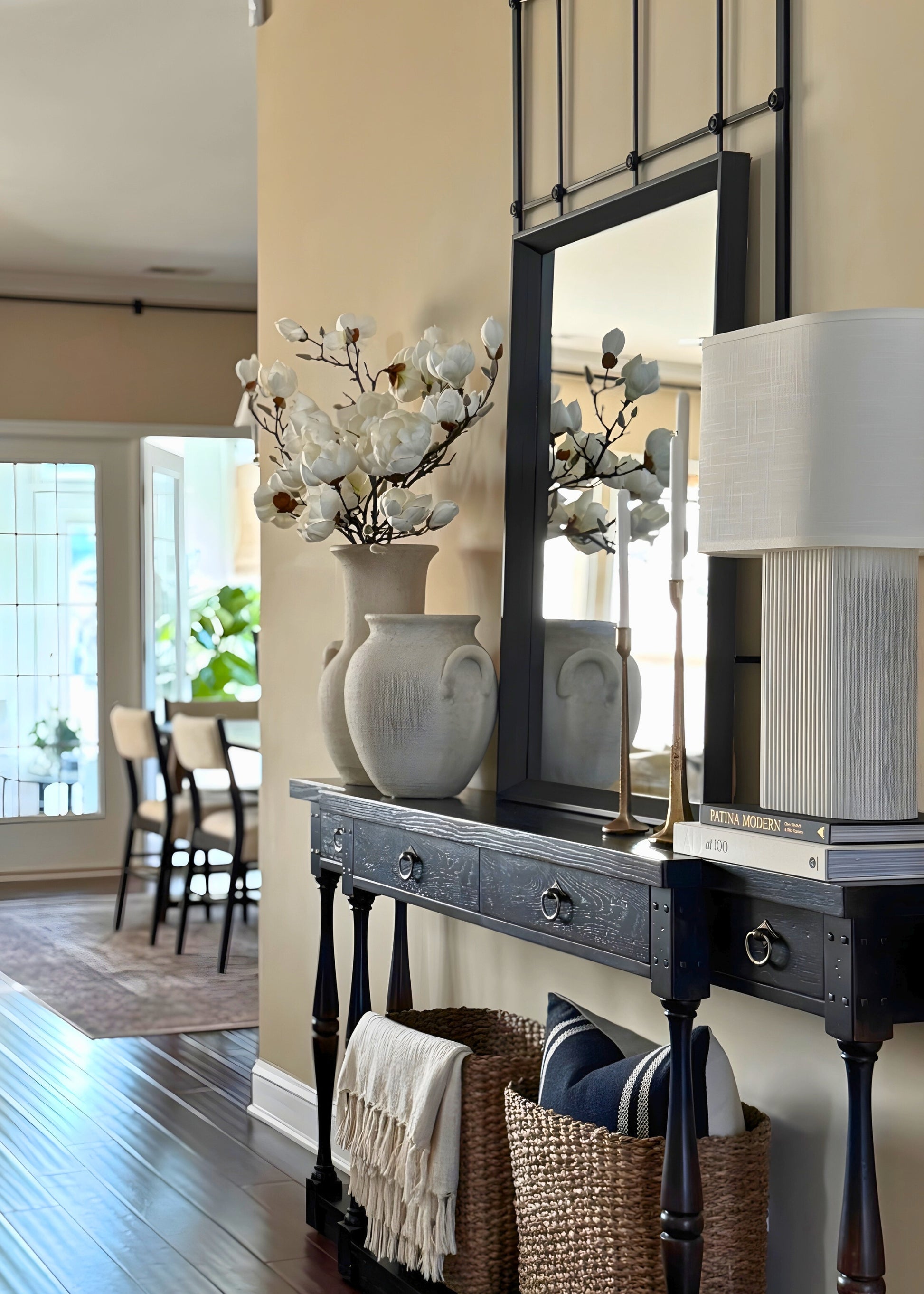 Decorative console table with vase full of faux magnolias