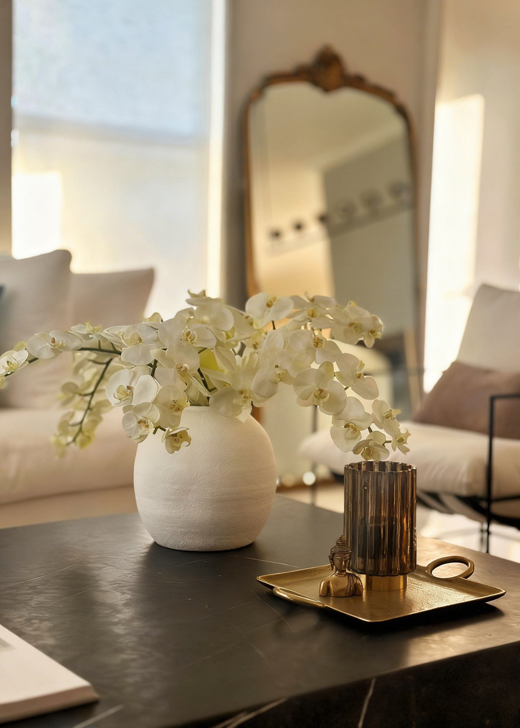 White Konos vase with premium artificial orchid flowers on a coffee table