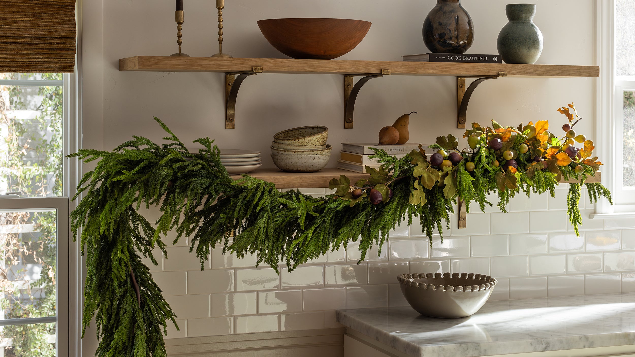 Decorative shelf with plants, bowls, and a vase in a kitchen setting.